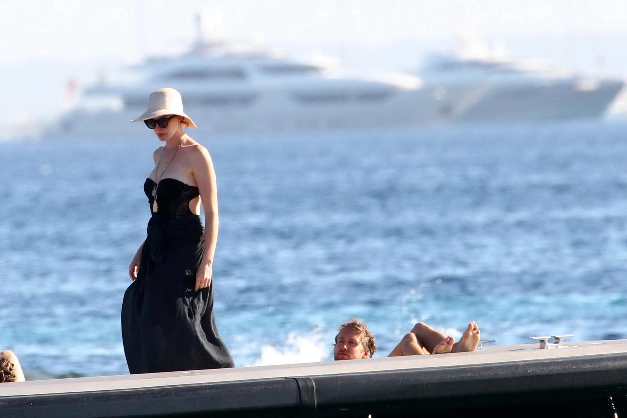 16P Anne Hathaway busty wearing a strapless black swimsuit
