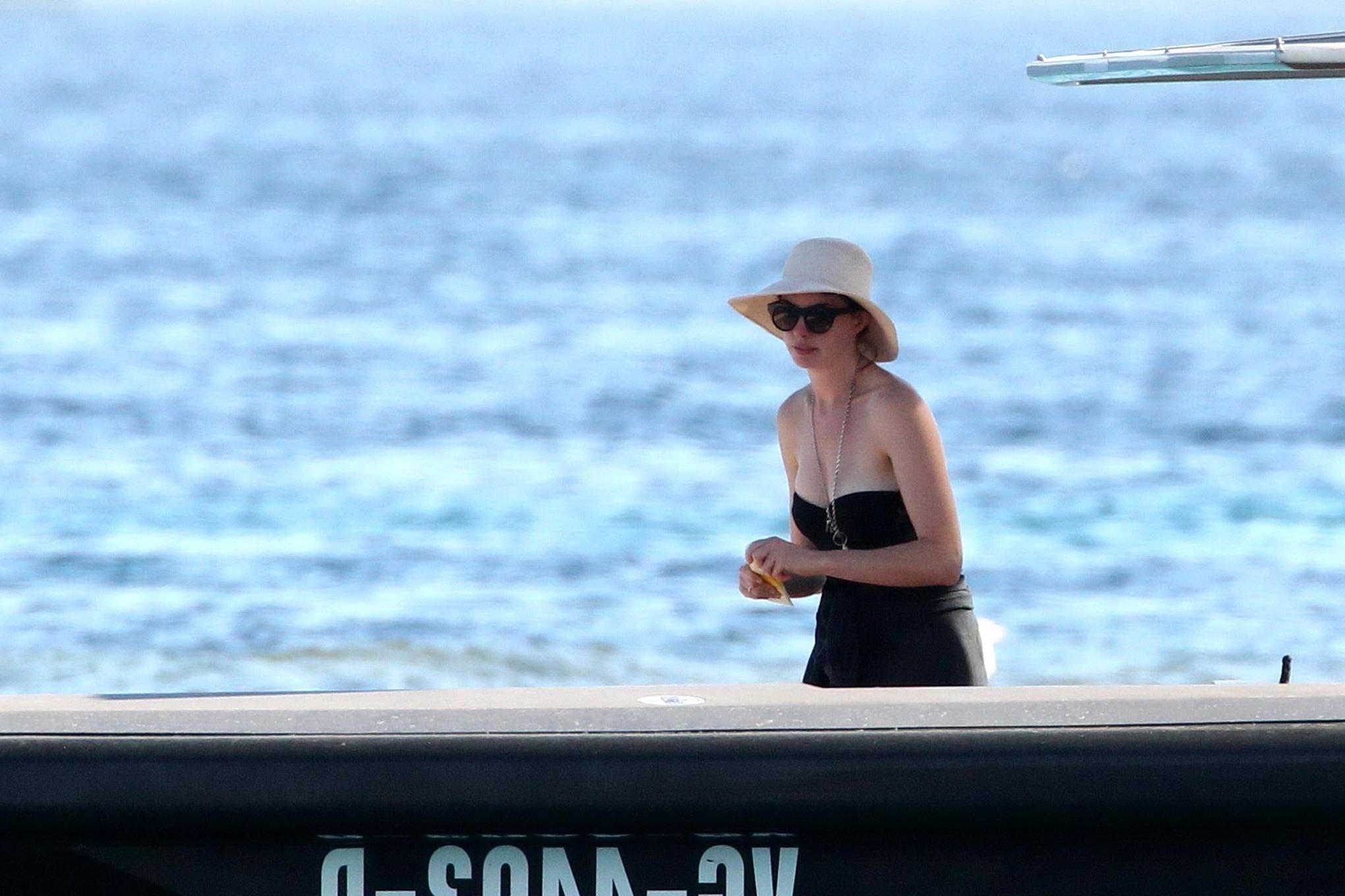 16P Anne Hathaway busty wearing a strapless black swimsuit
