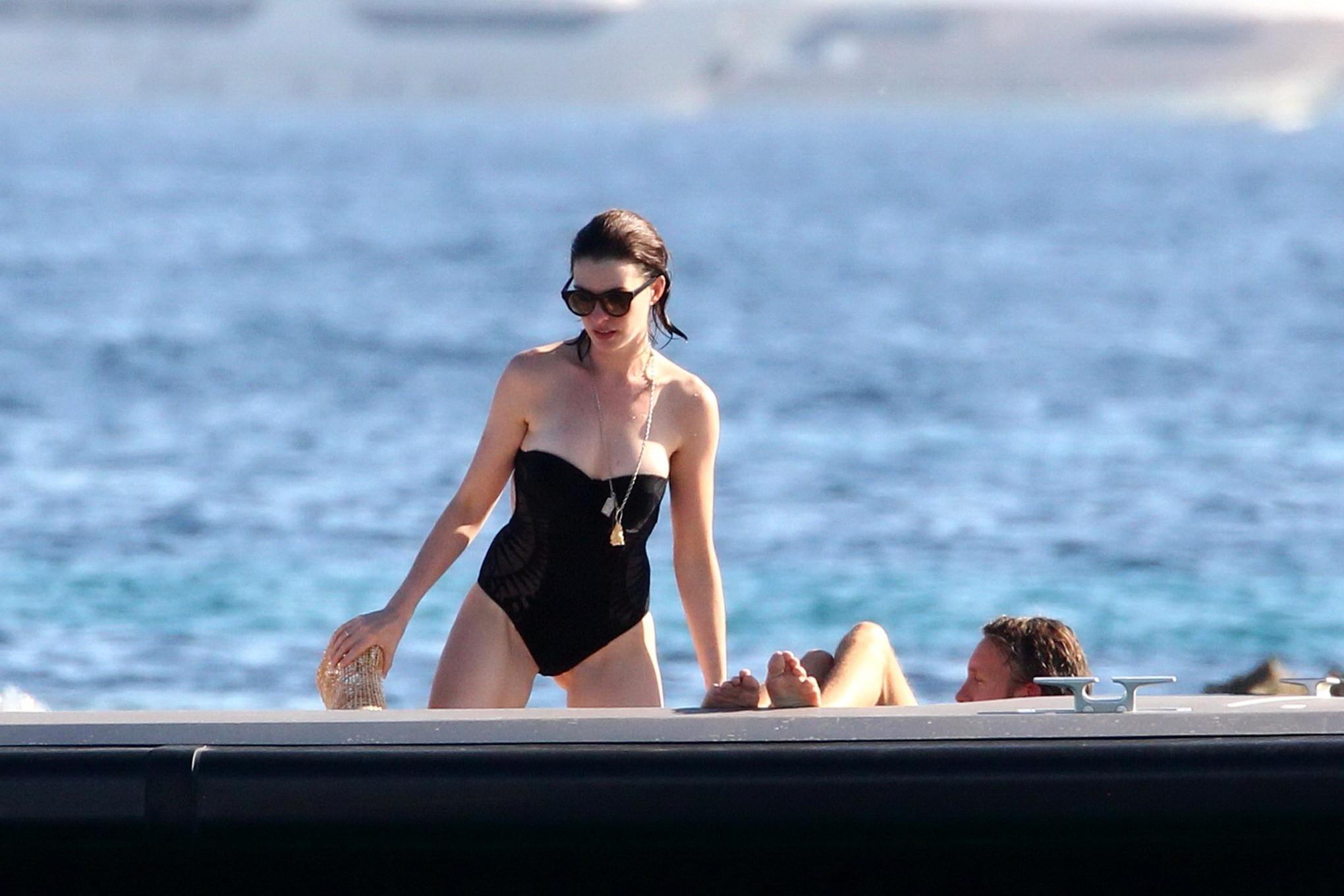 16P Anne Hathaway busty wearing a strapless black swimsuit