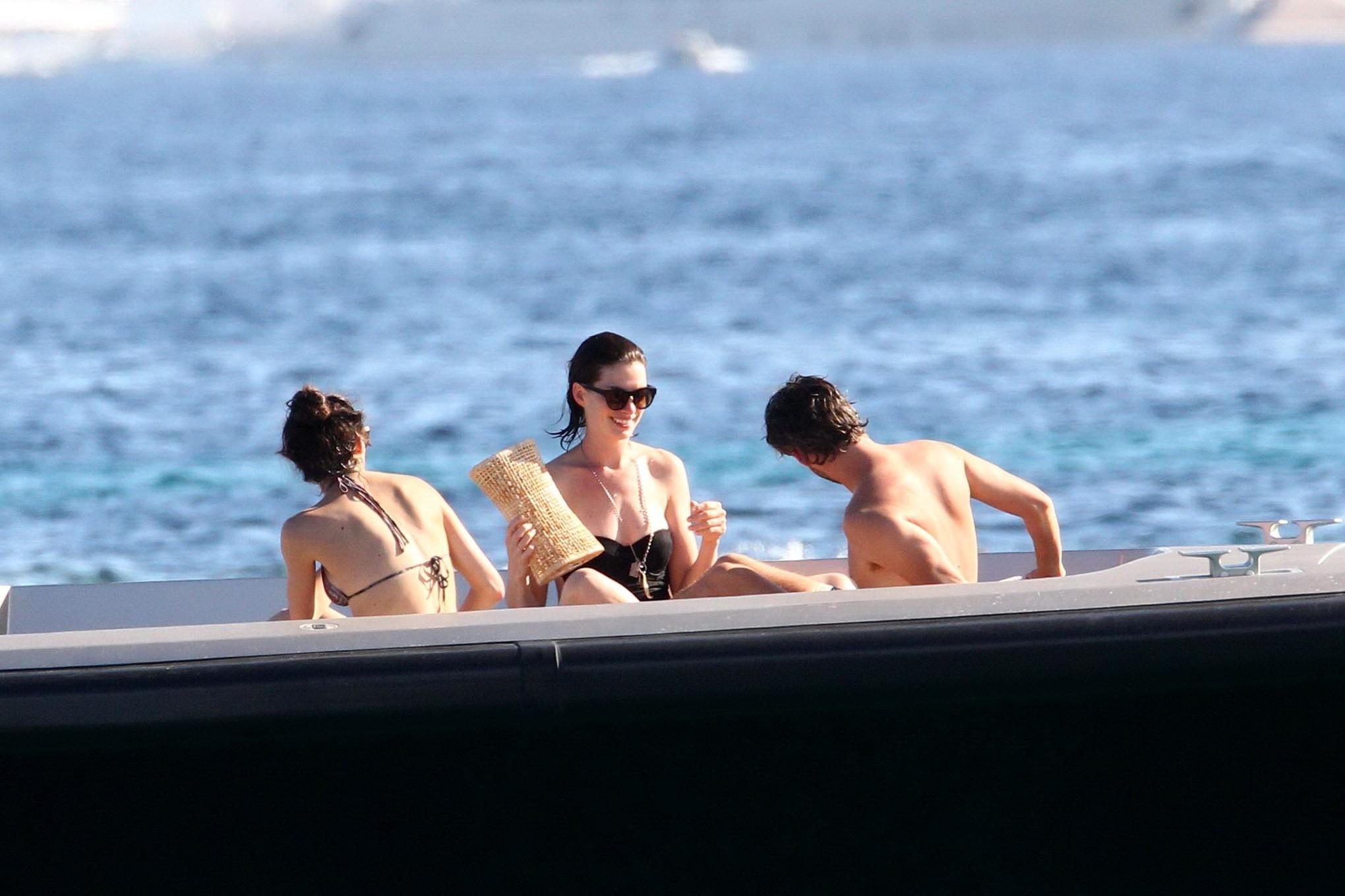 16P Anne Hathaway busty wearing a strapless black swimsuit