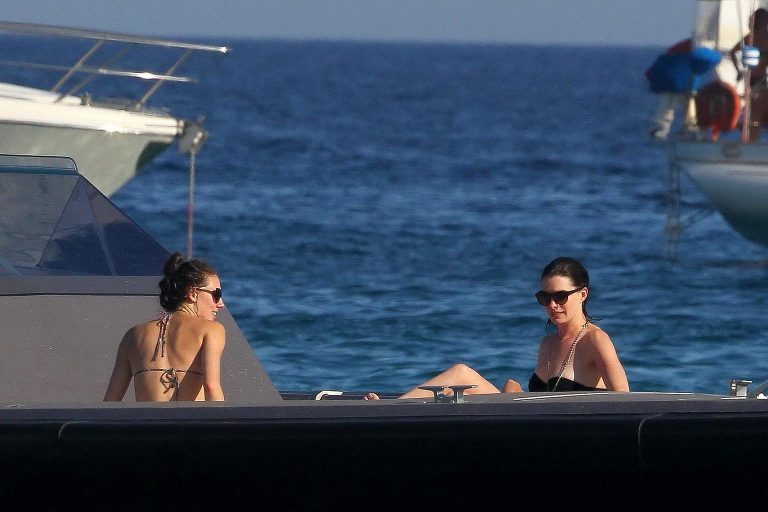 16P Anne Hathaway busty wearing a strapless black swimsuit