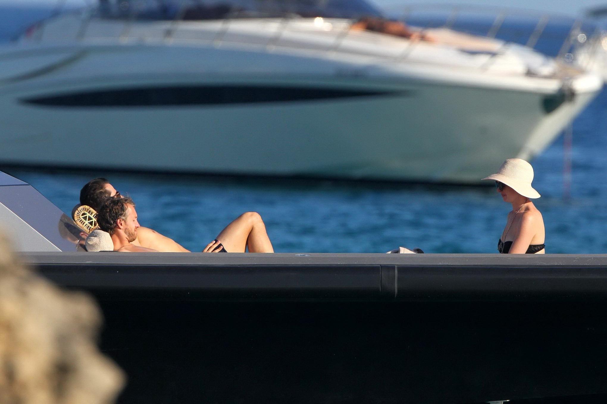 16P Anne Hathaway busty wearing a strapless black swimsuit
