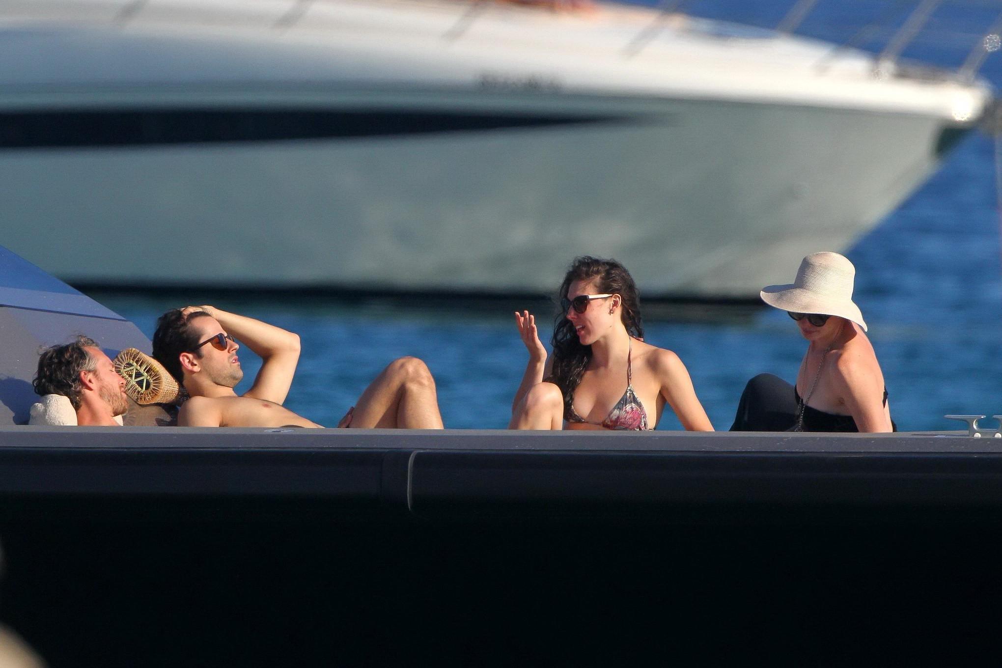 16P Anne Hathaway busty wearing a strapless black swimsuit