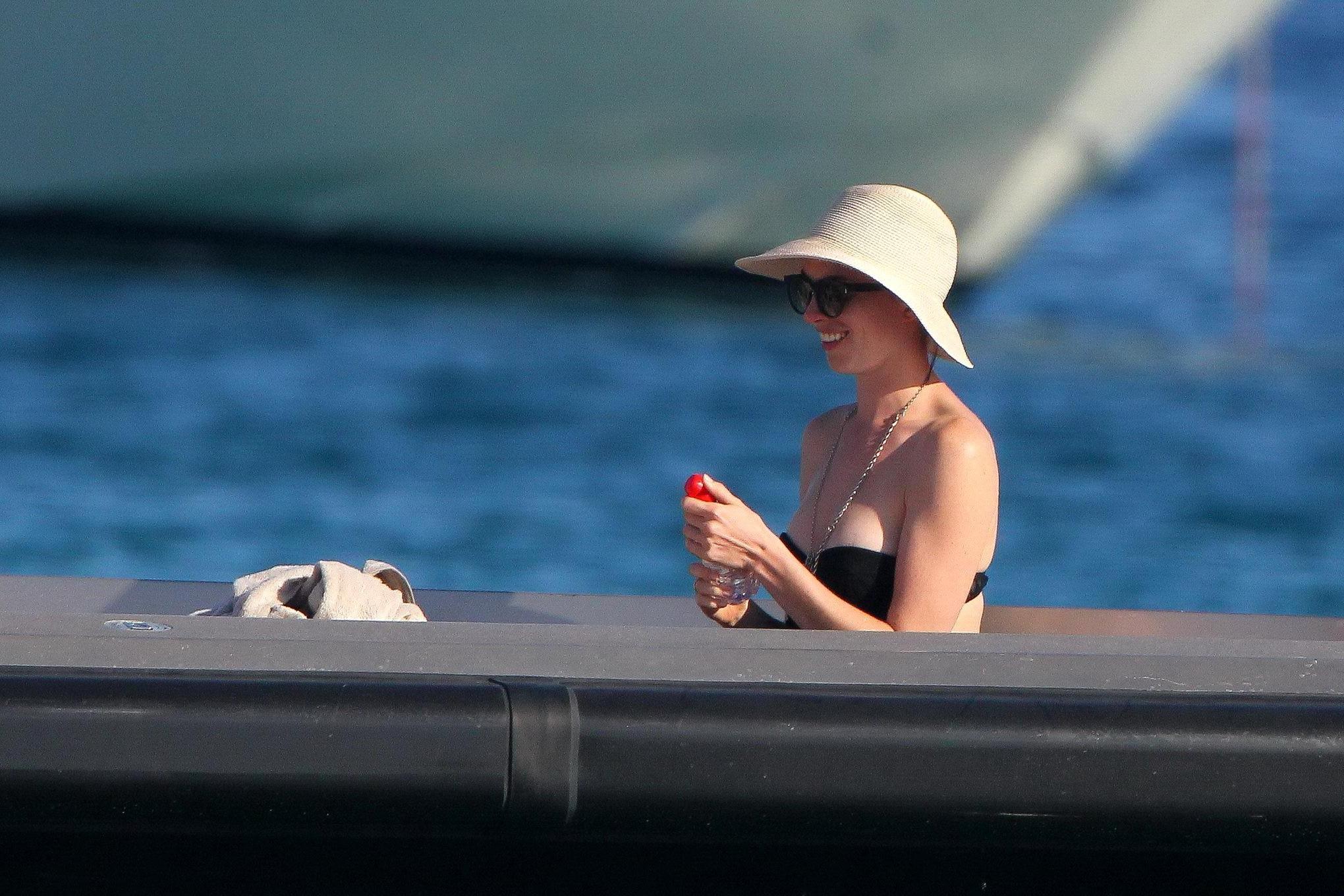 16P Anne Hathaway busty wearing a strapless black swimsuit