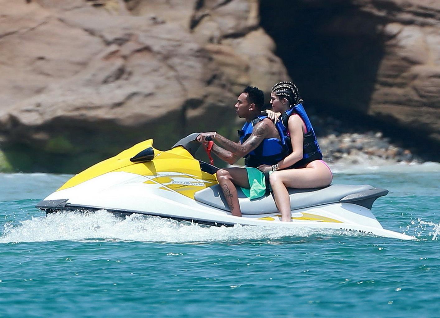16P Kylie Jenner shows off her curvy body in a pink swimsuit