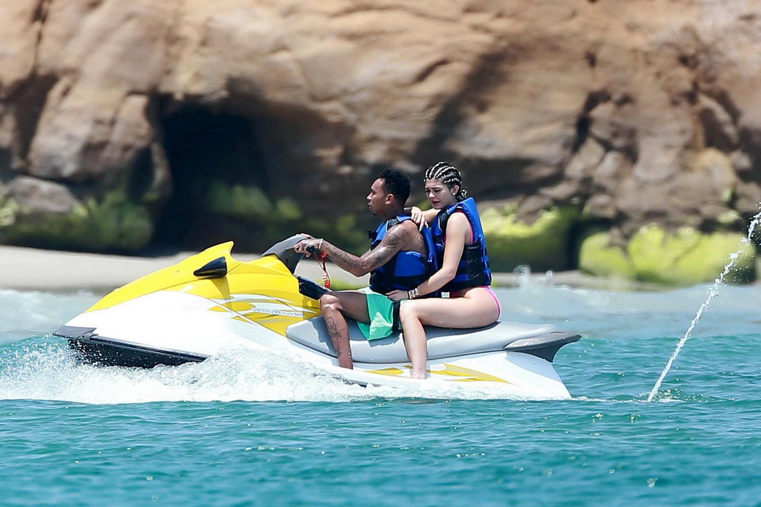 16P Kylie Jenner shows off her curvy body in a pink swimsuit