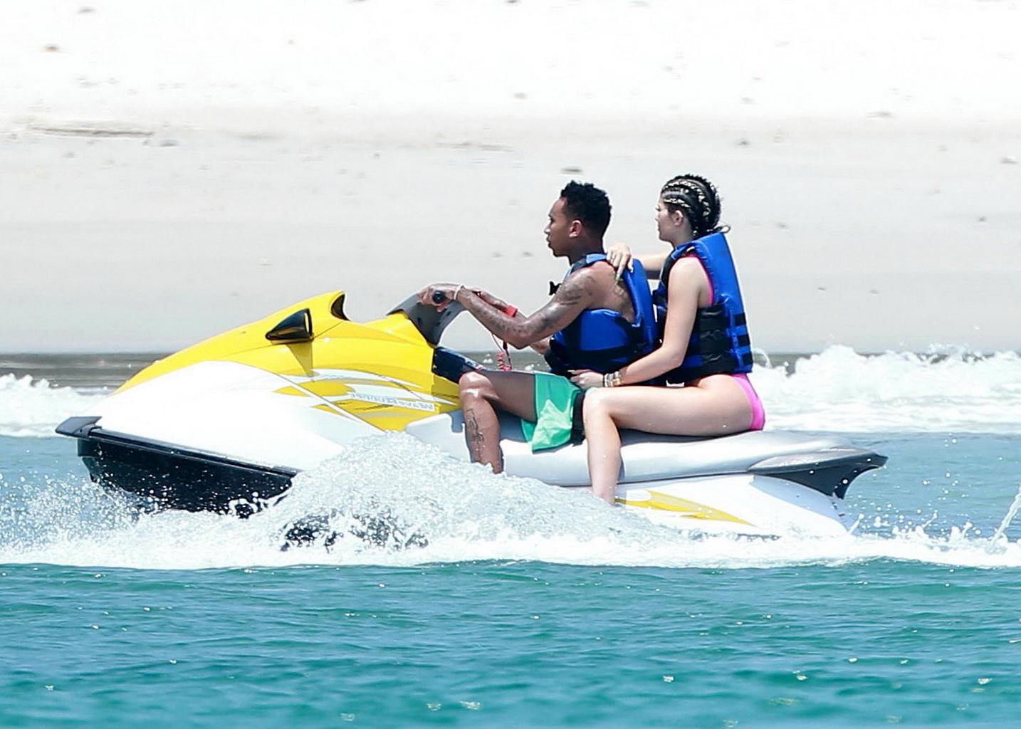 16P Kylie Jenner shows off her curvy body in a pink swimsuit