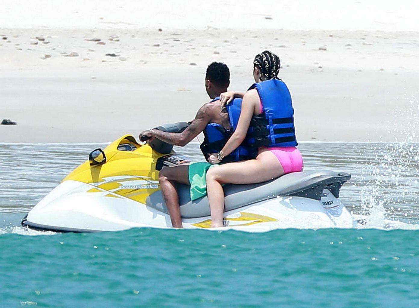 16P Kylie Jenner shows off her curvy body in a pink swimsuit