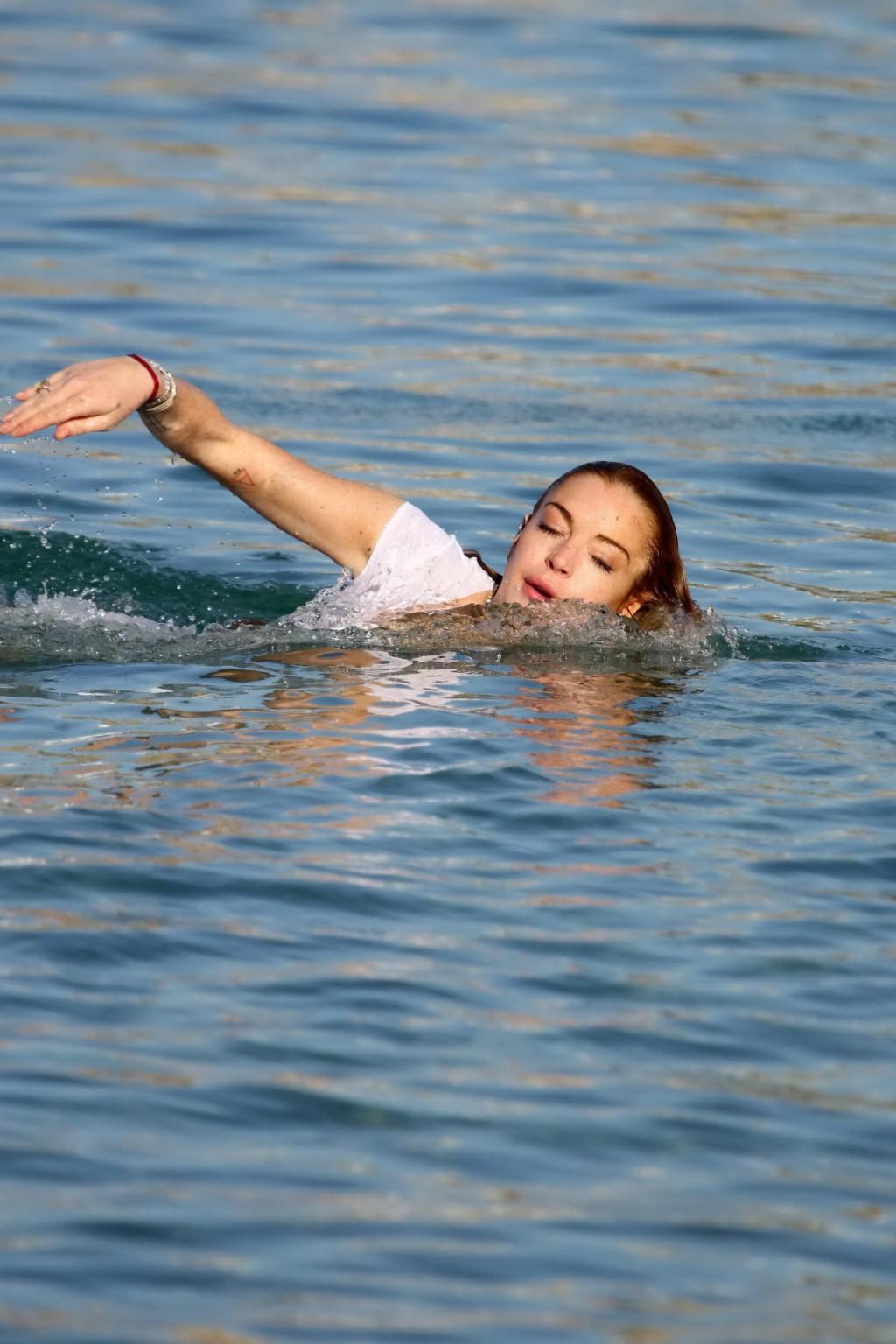 16P Lindsay Lohan busty in bizarre white seethrough swimsuit