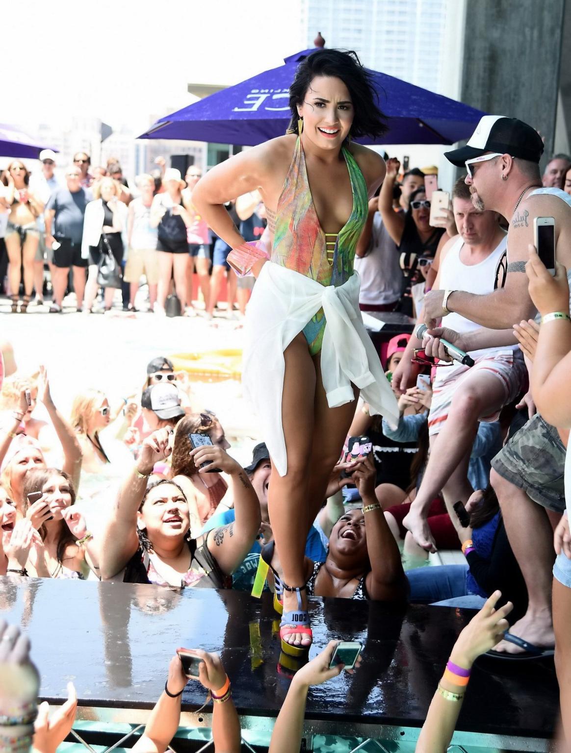 16P Demi Lovato getting wet in low cut swimsuit poolside