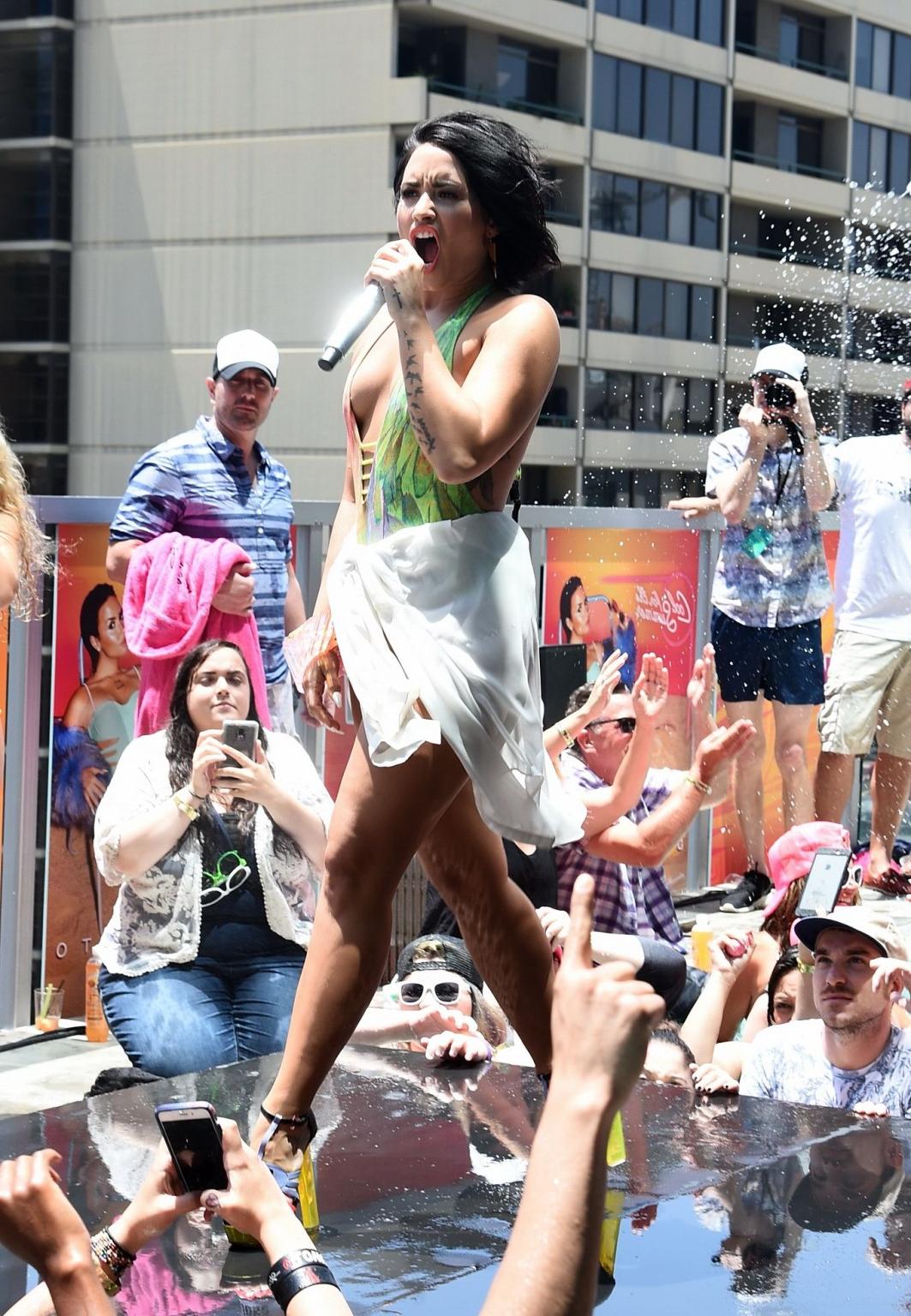 16P Demi Lovato getting wet in low cut swimsuit poolside
