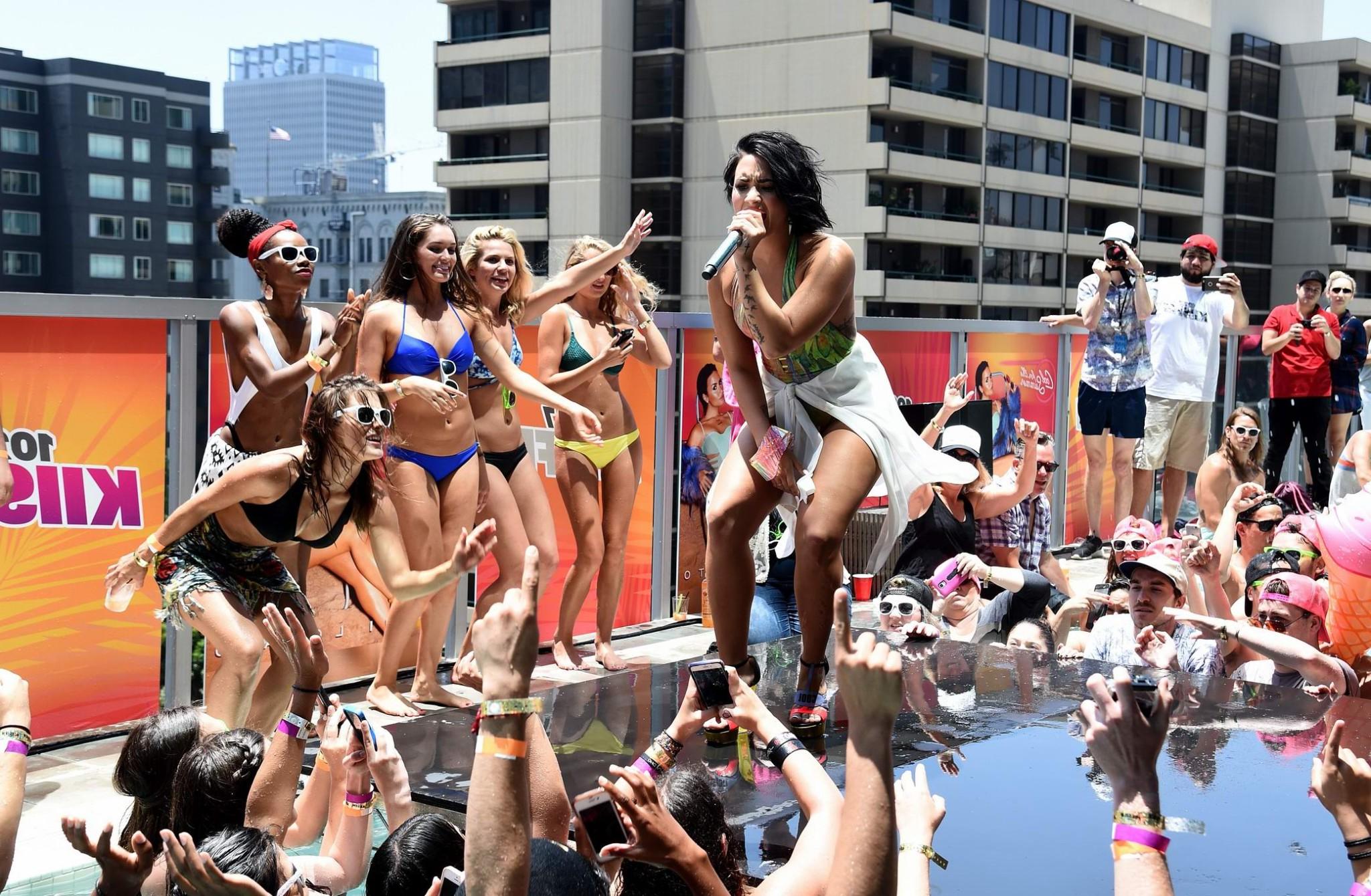 16P Demi Lovato getting wet in low cut swimsuit poolside