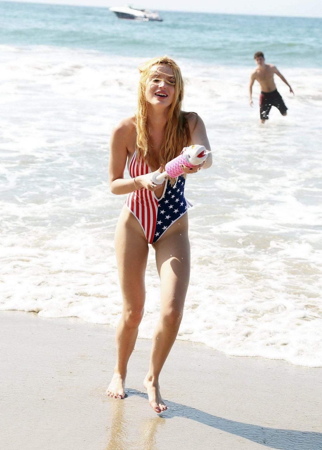 16P Bella Thorne in low cut national colored swimsuit