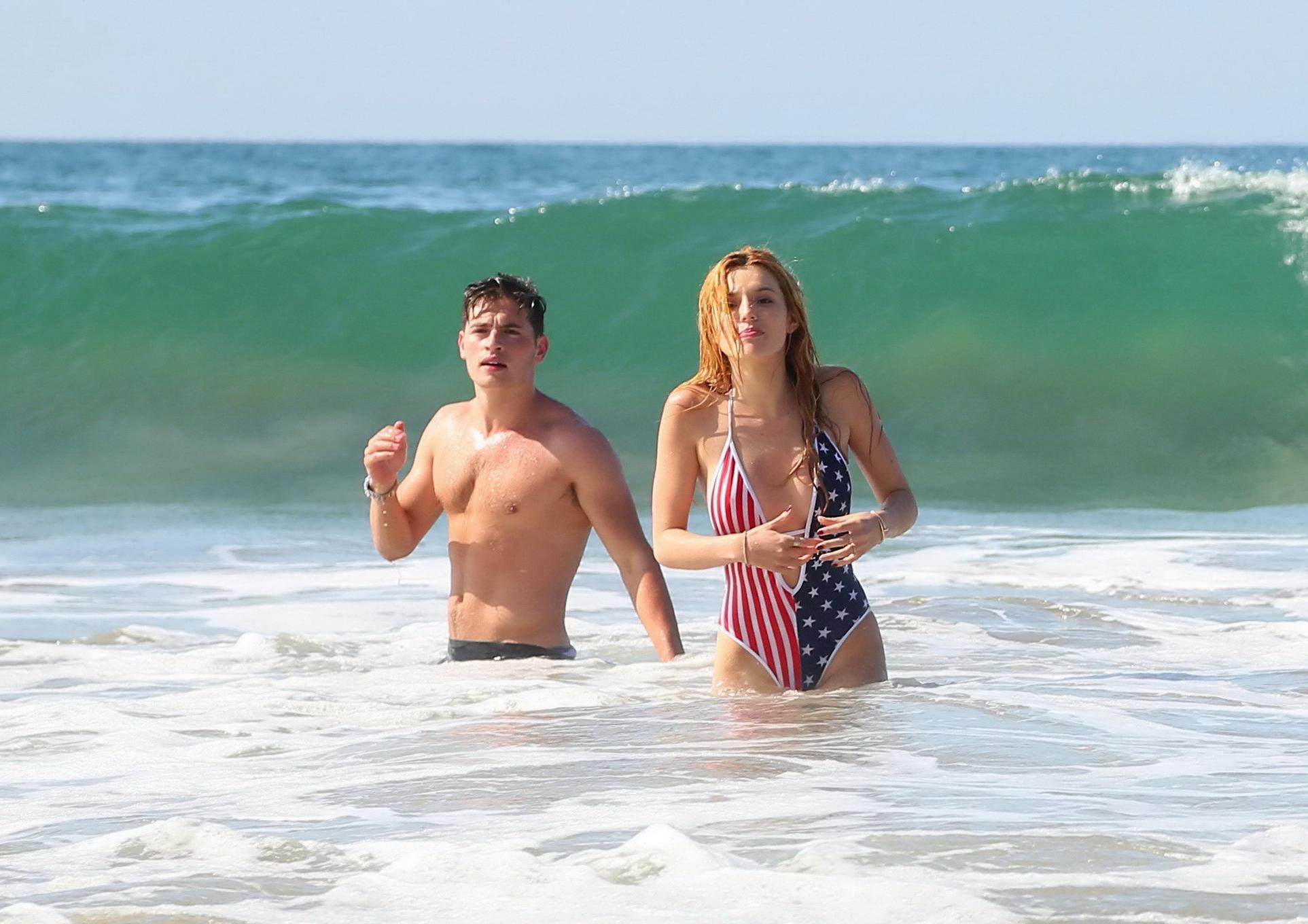 16P Bella Thorne in low cut national colored swimsuit
