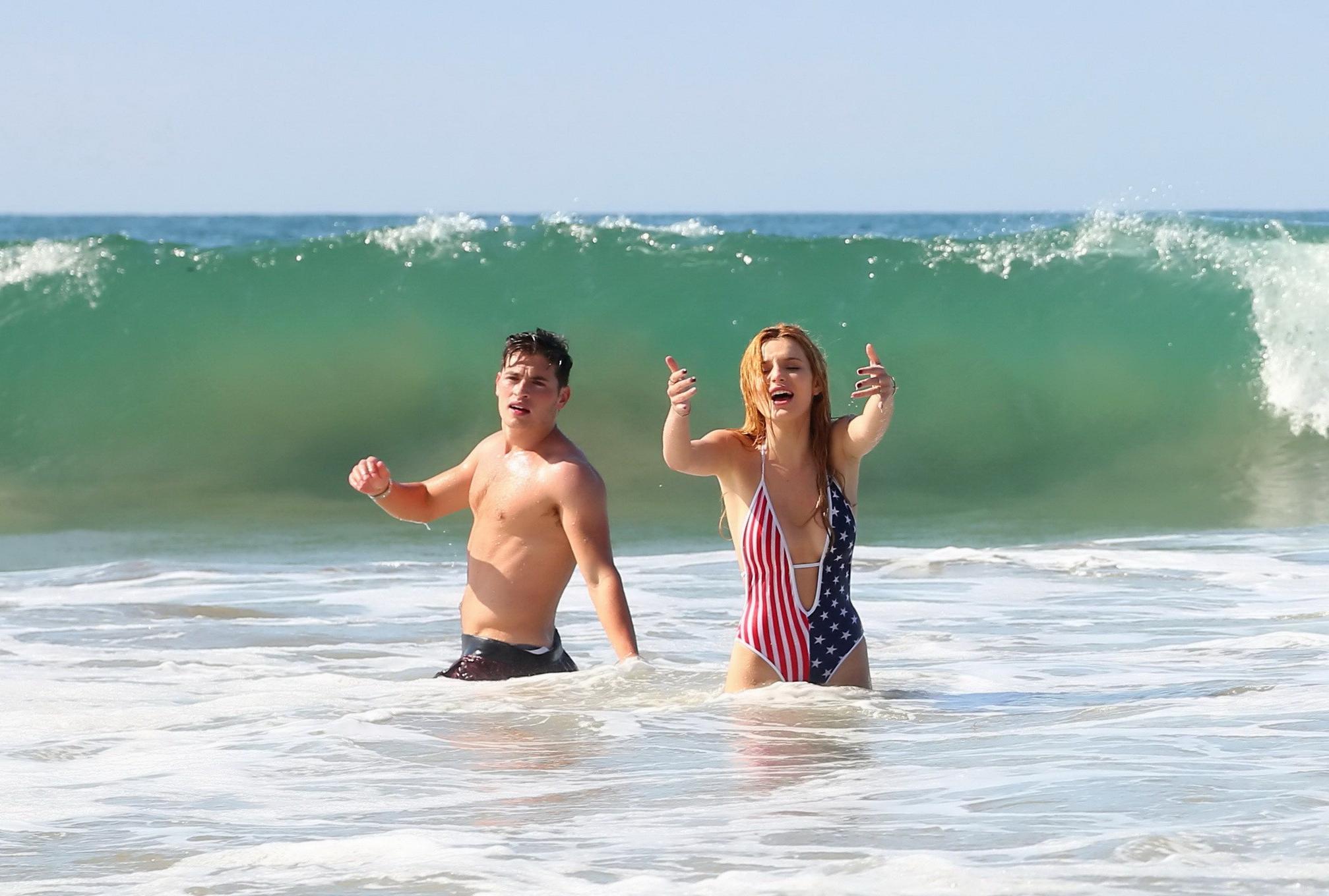 16P Bella Thorne in low cut national colored swimsuit