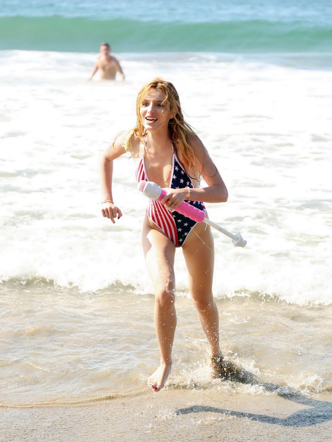 16P Bella Thorne in low cut national colored swimsuit