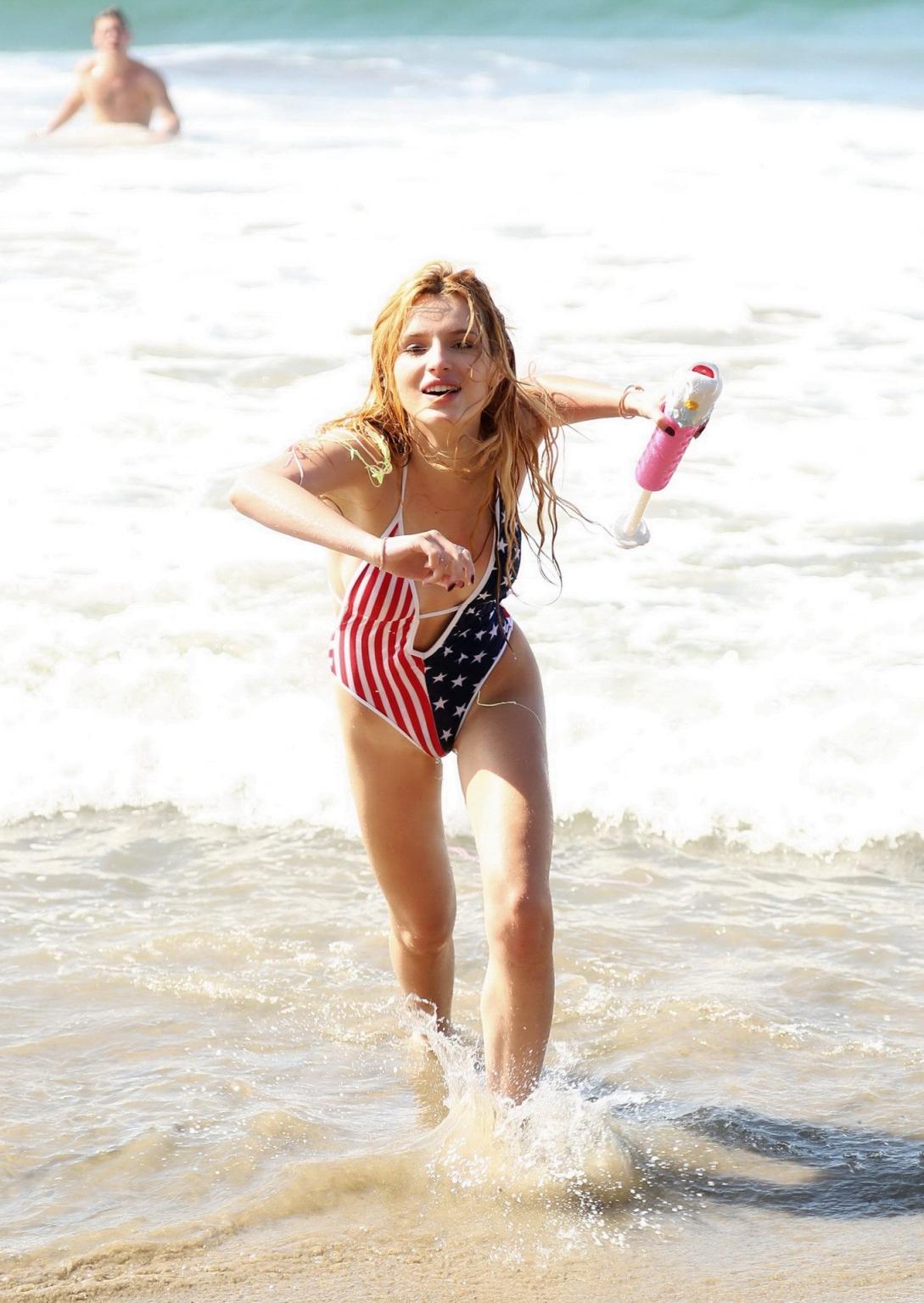 16P Bella Thorne in low cut national colored swimsuit
