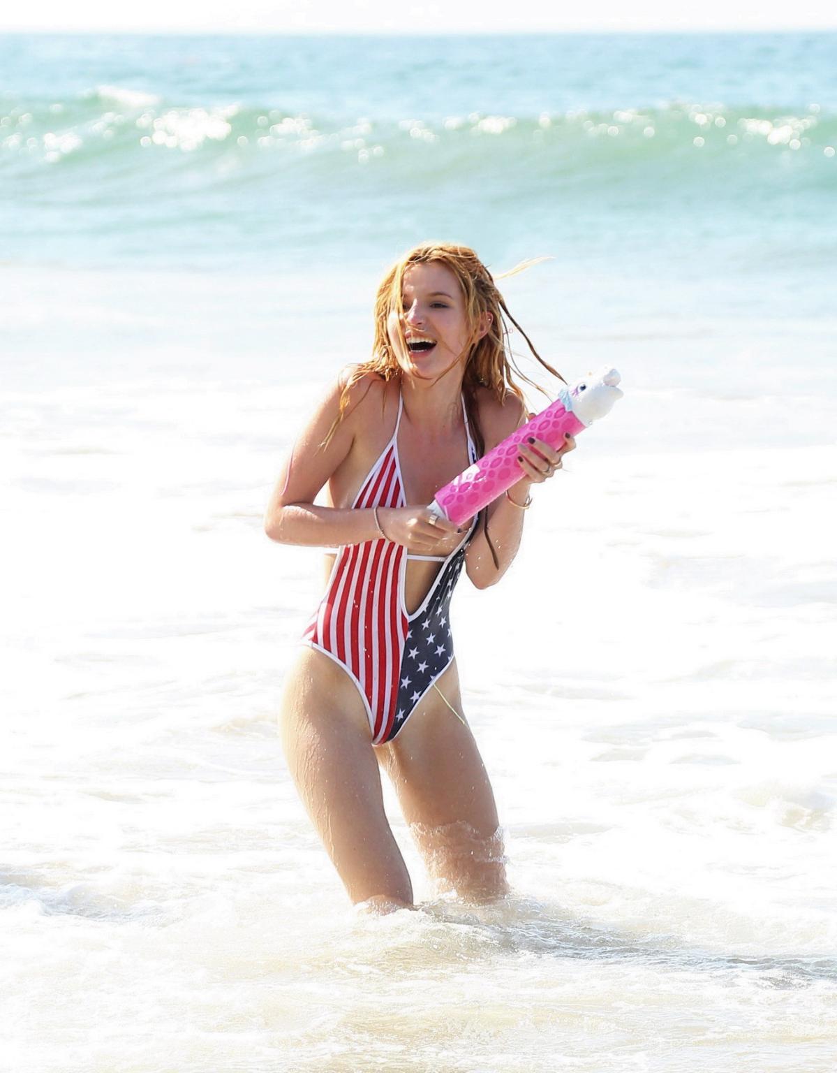 16P Bella Thorne in low cut national colored swimsuit