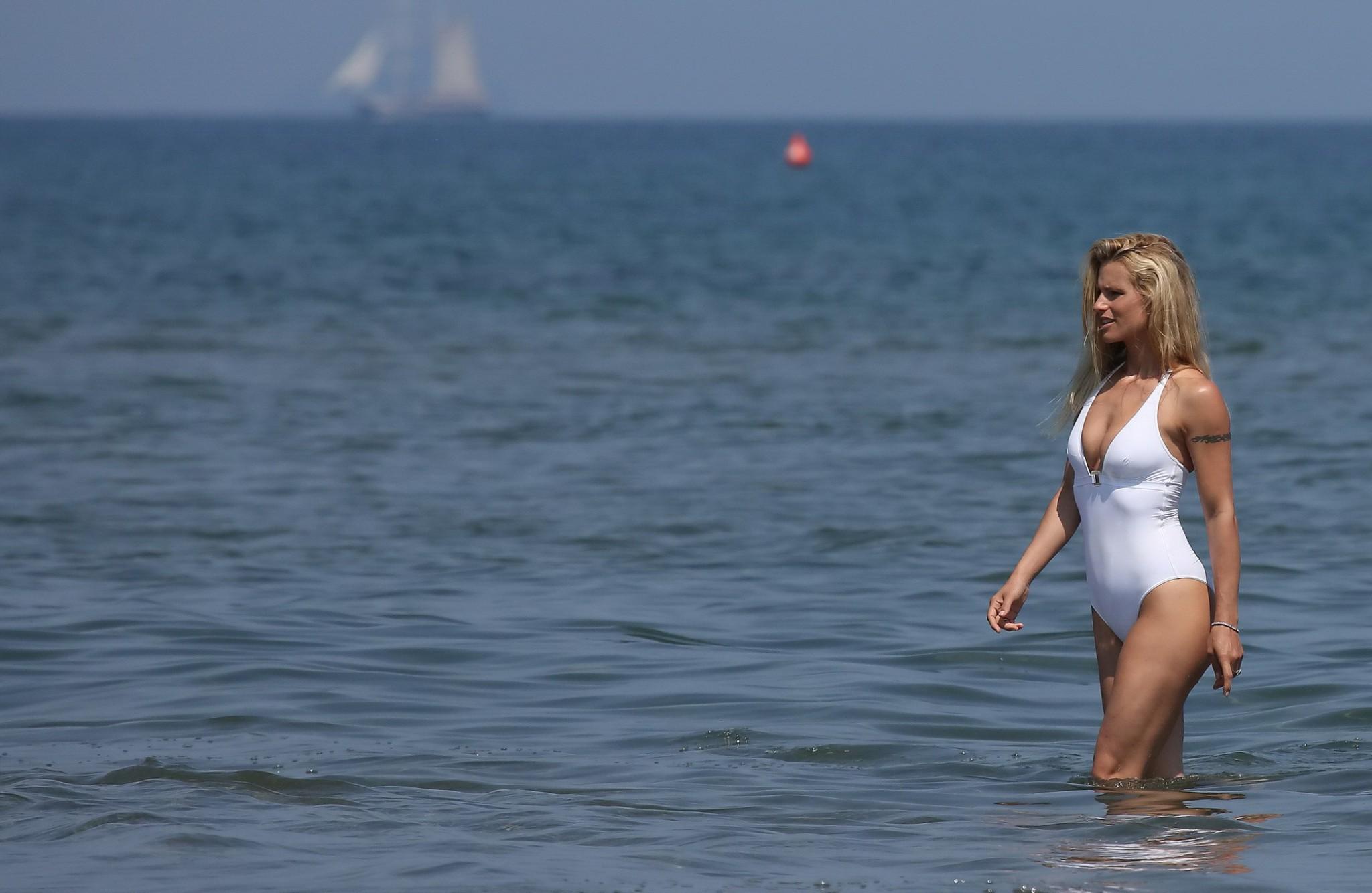 16P Michelle Hunziker flashing her boobs and pussy in white swimsuit at the beach in