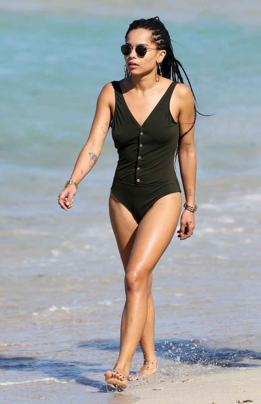 16P Zoe Kravitz showing hard pokies and ass in black swimsuit at the beach in Miami