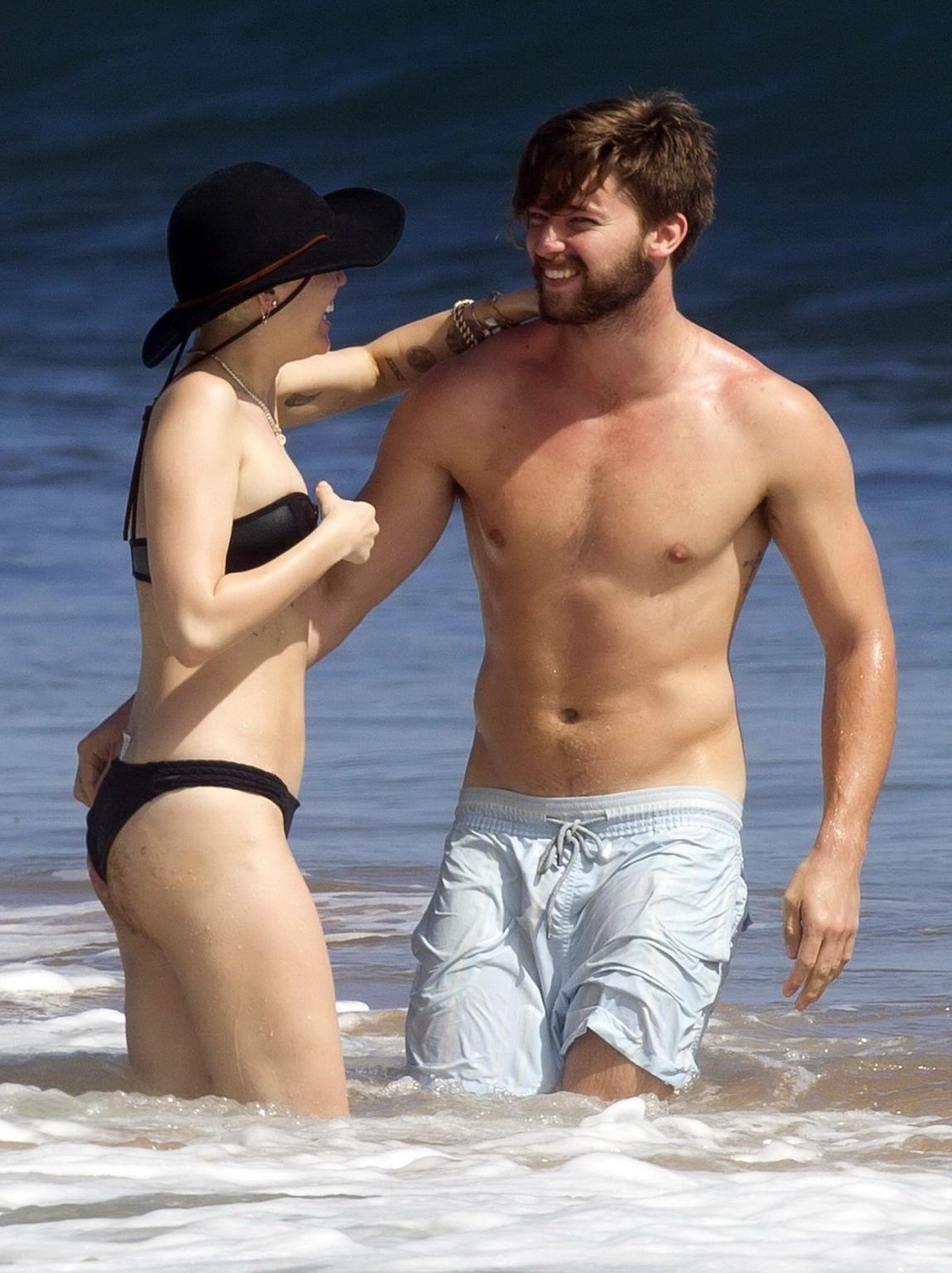 16P Miley Cyrus showing off her bikini body and getting her ass groped on a Hawaiian
