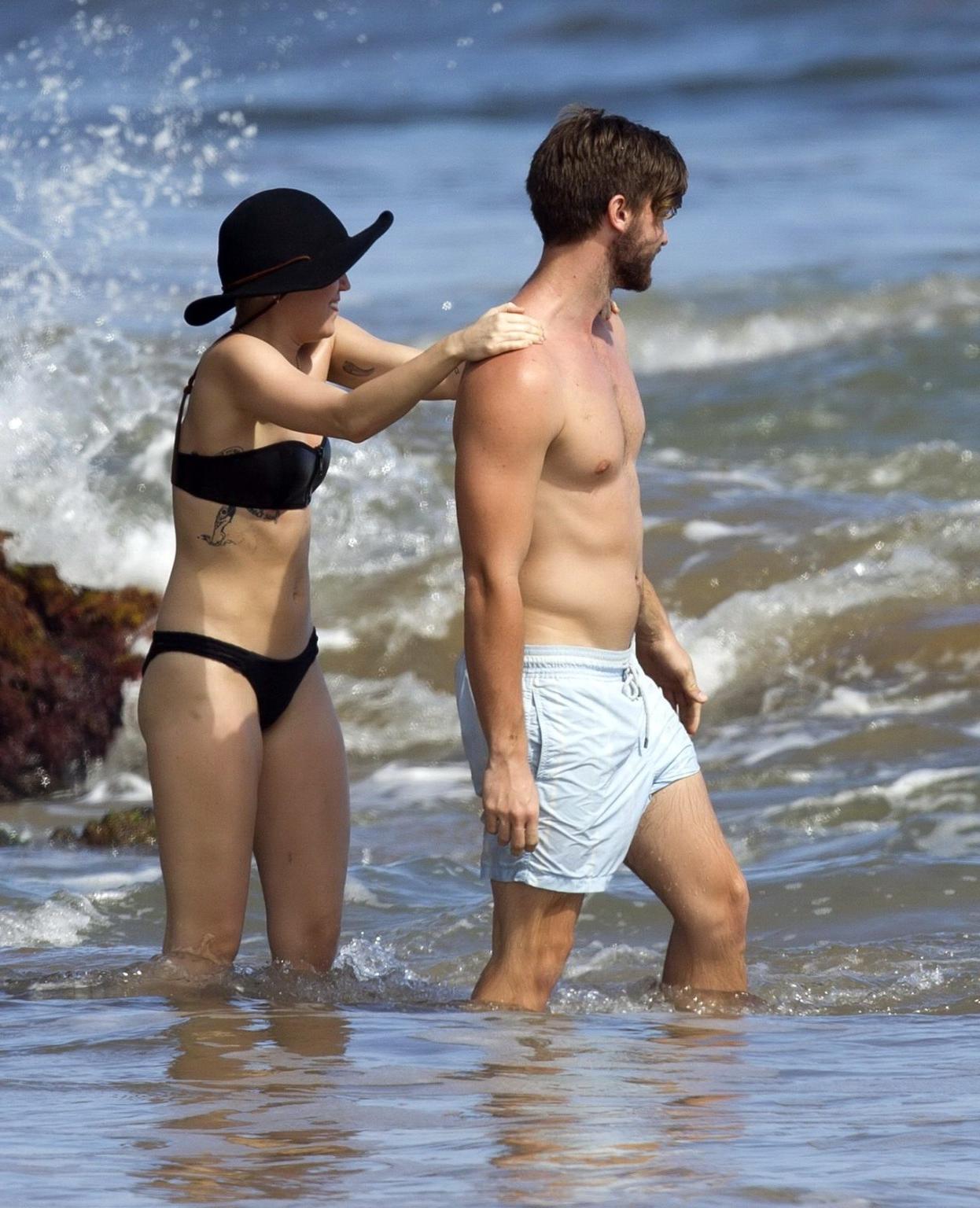 16P Miley Cyrus showing off her bikini body and getting her ass groped on a Hawaiian