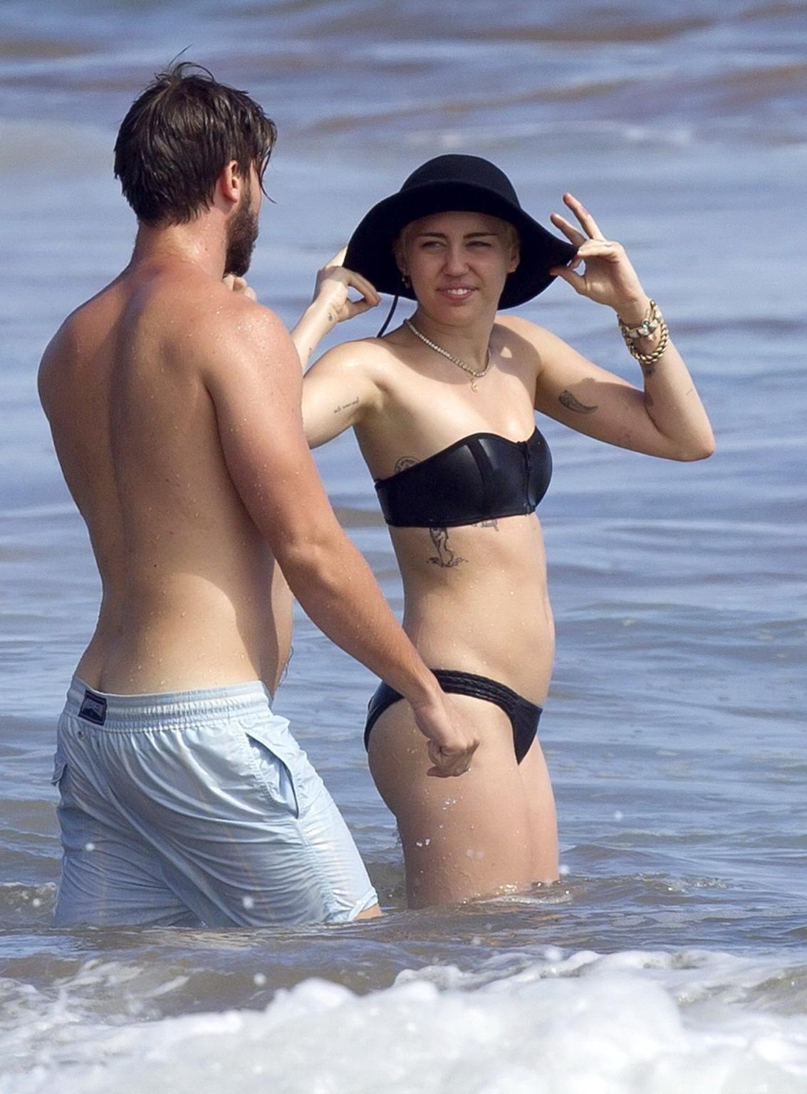 16P Miley Cyrus showing off her bikini body and getting her ass groped on a Hawaiian