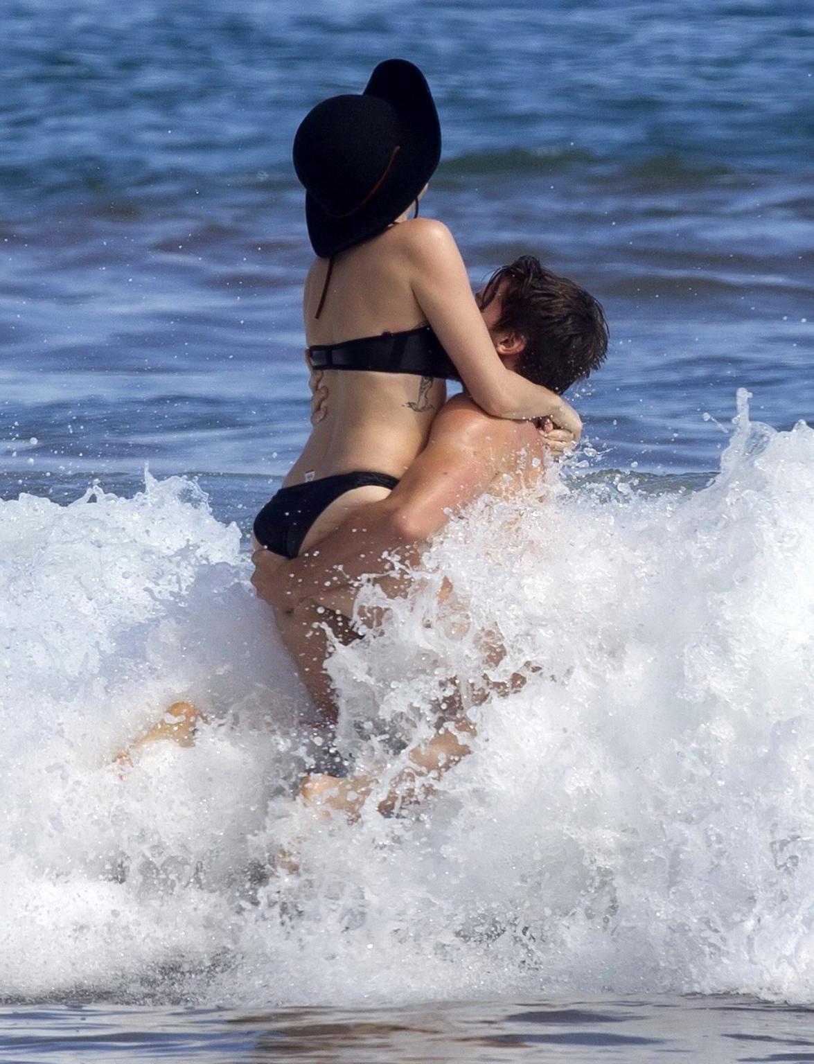 16P Miley Cyrus showing off her bikini body and getting her ass groped on a Hawaiian