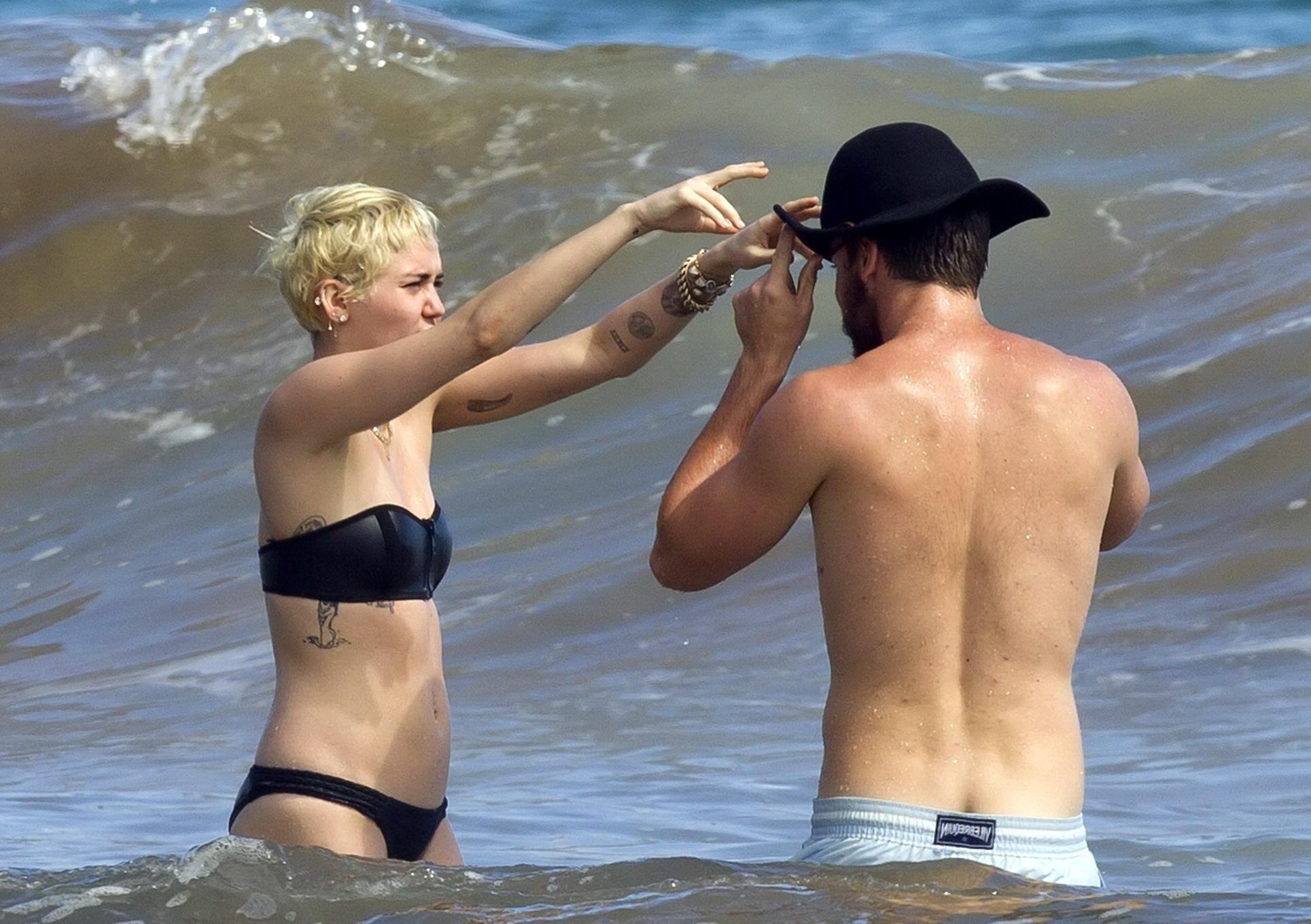 16P Miley Cyrus showing off her bikini body and getting her ass groped on a Hawaiian