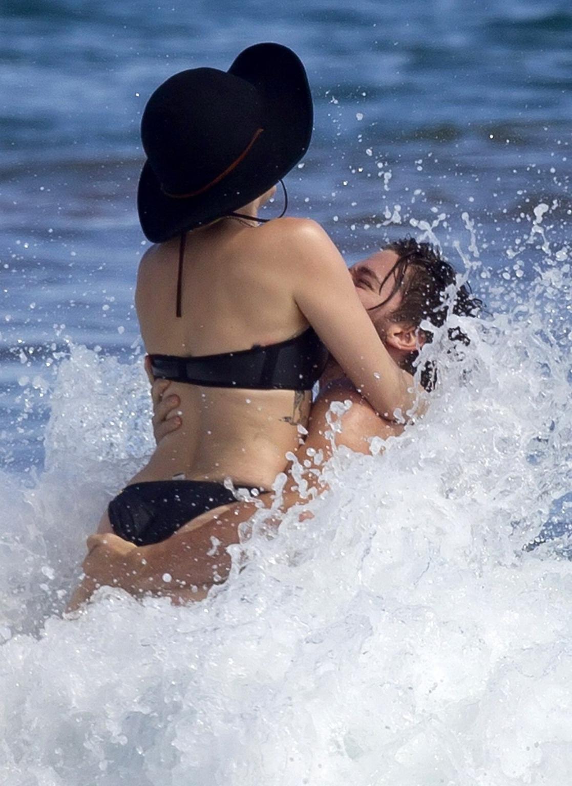 16P Miley Cyrus showing off her bikini body and getting her ass groped on a Hawaiian