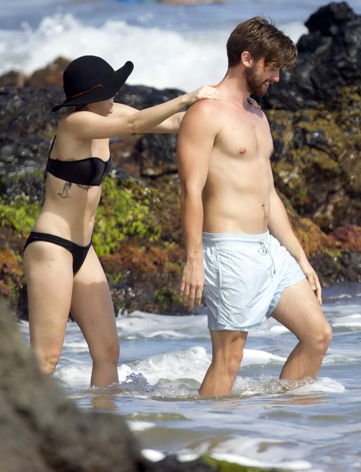 16P Miley Cyrus showing off her bikini body and getting her ass groped on a Hawaiian