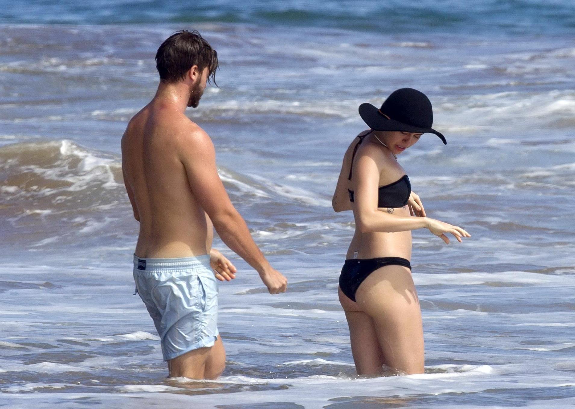 16P Miley Cyrus showing off her bikini body and getting her ass groped on a Hawaiian