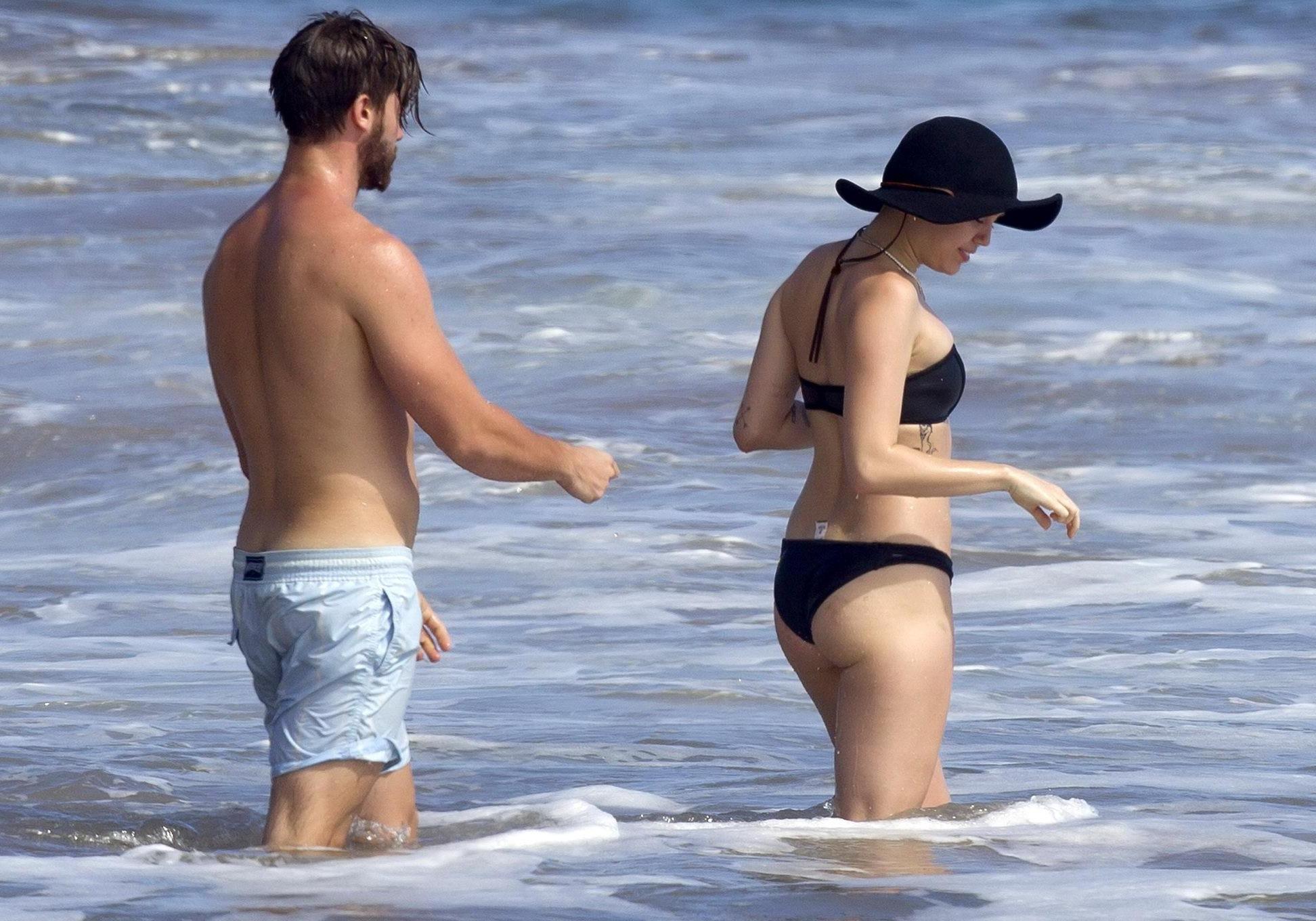 16P Miley Cyrus showing off her bikini body and getting her ass groped on a Hawaiian