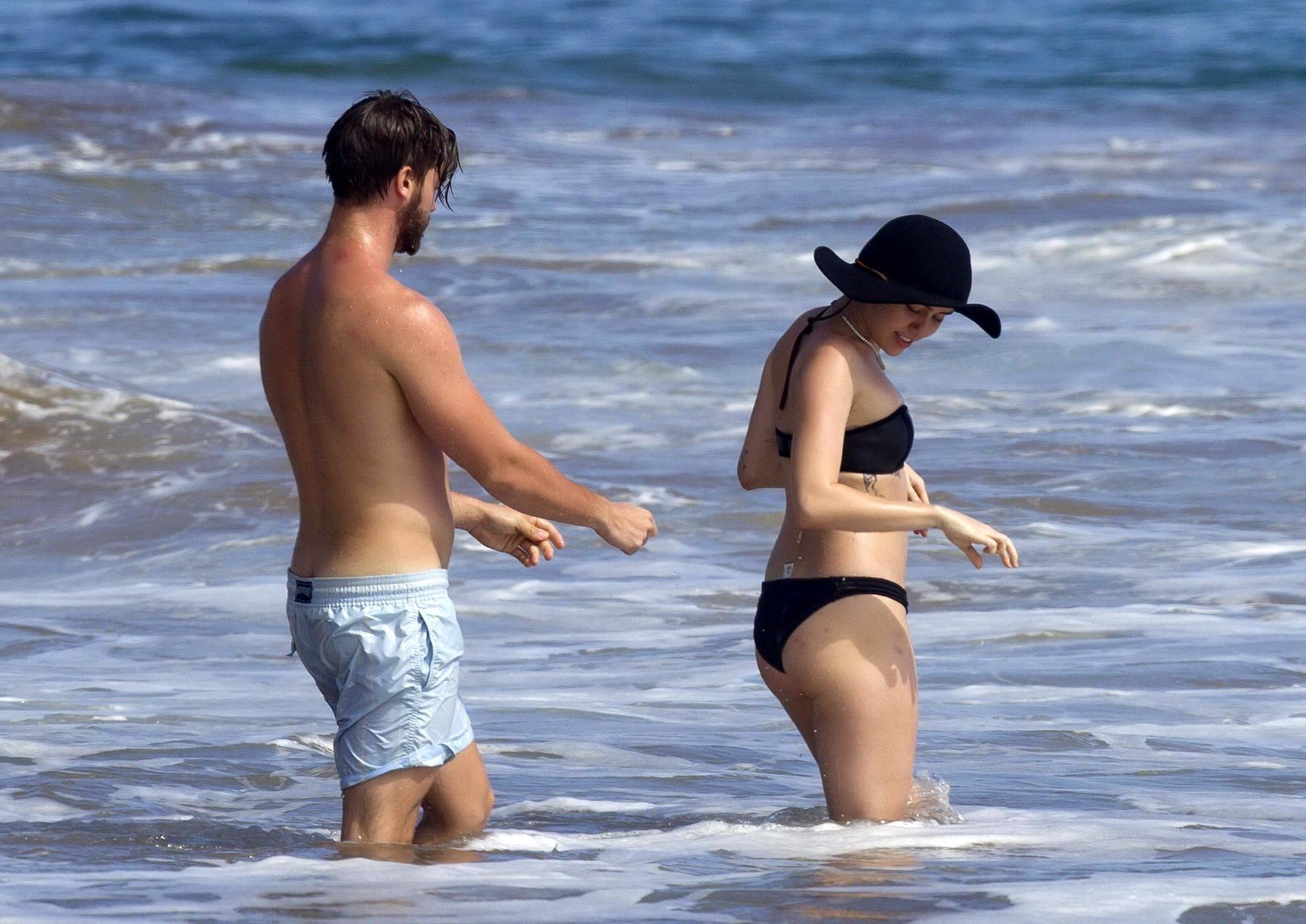16P Miley Cyrus showing off her bikini body and getting her ass groped on a Hawaiian