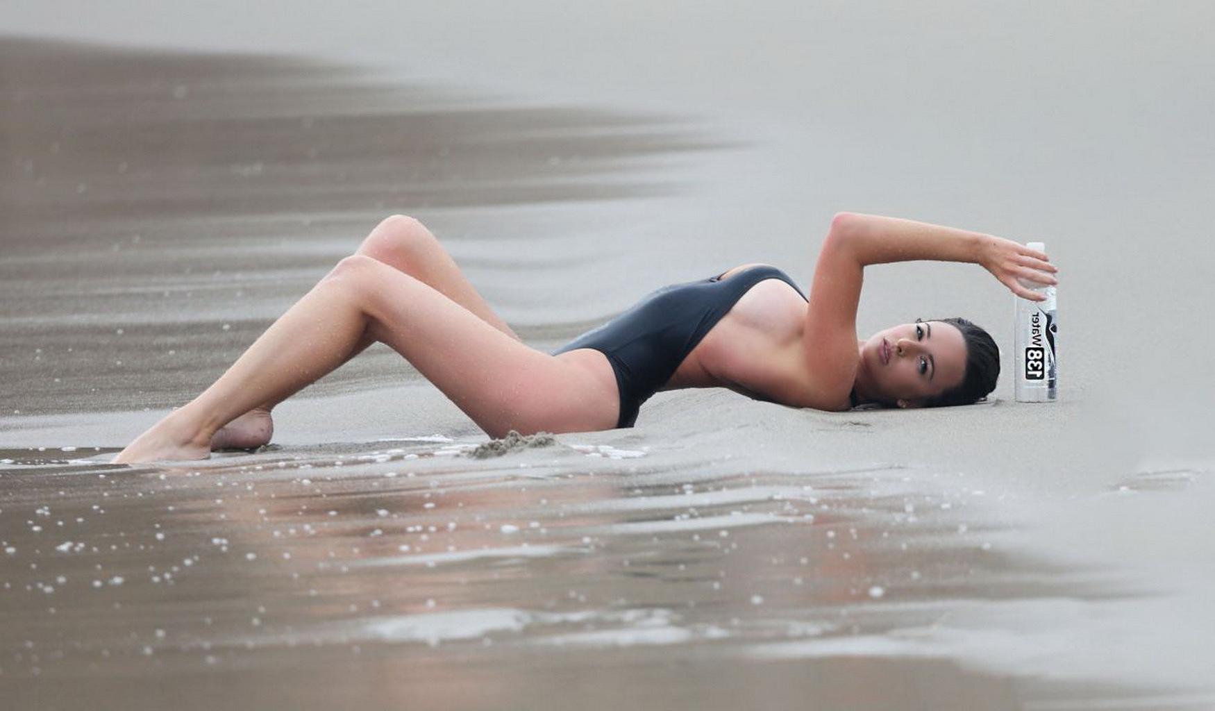 16P Kayla Swift shows sideboob and pokies in black swimsuit while freezing on the be