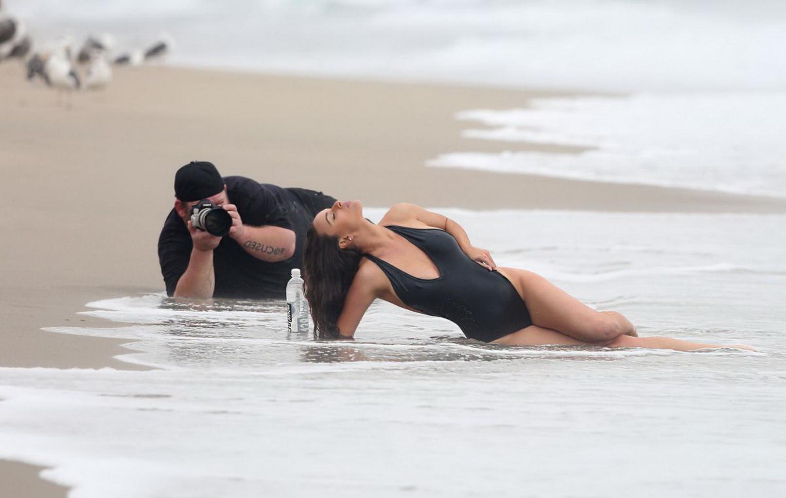 16P Kayla Swift shows sideboob and pokies in black swimsuit while freezing on the be