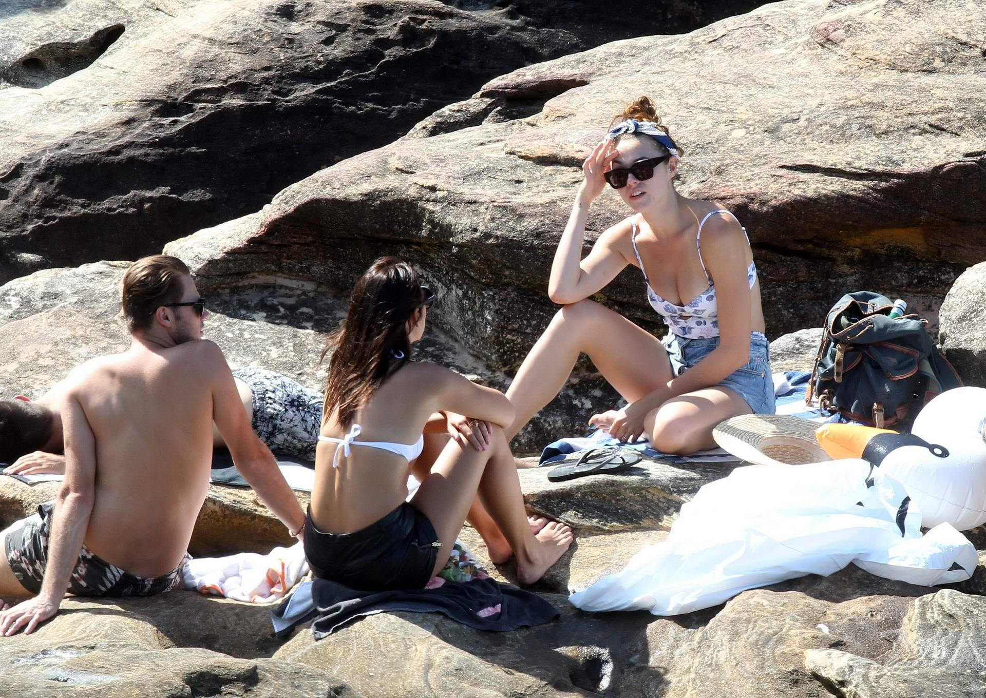 16P Demi Harman busty wearing a swimsuit on a rocky beach in Sydney