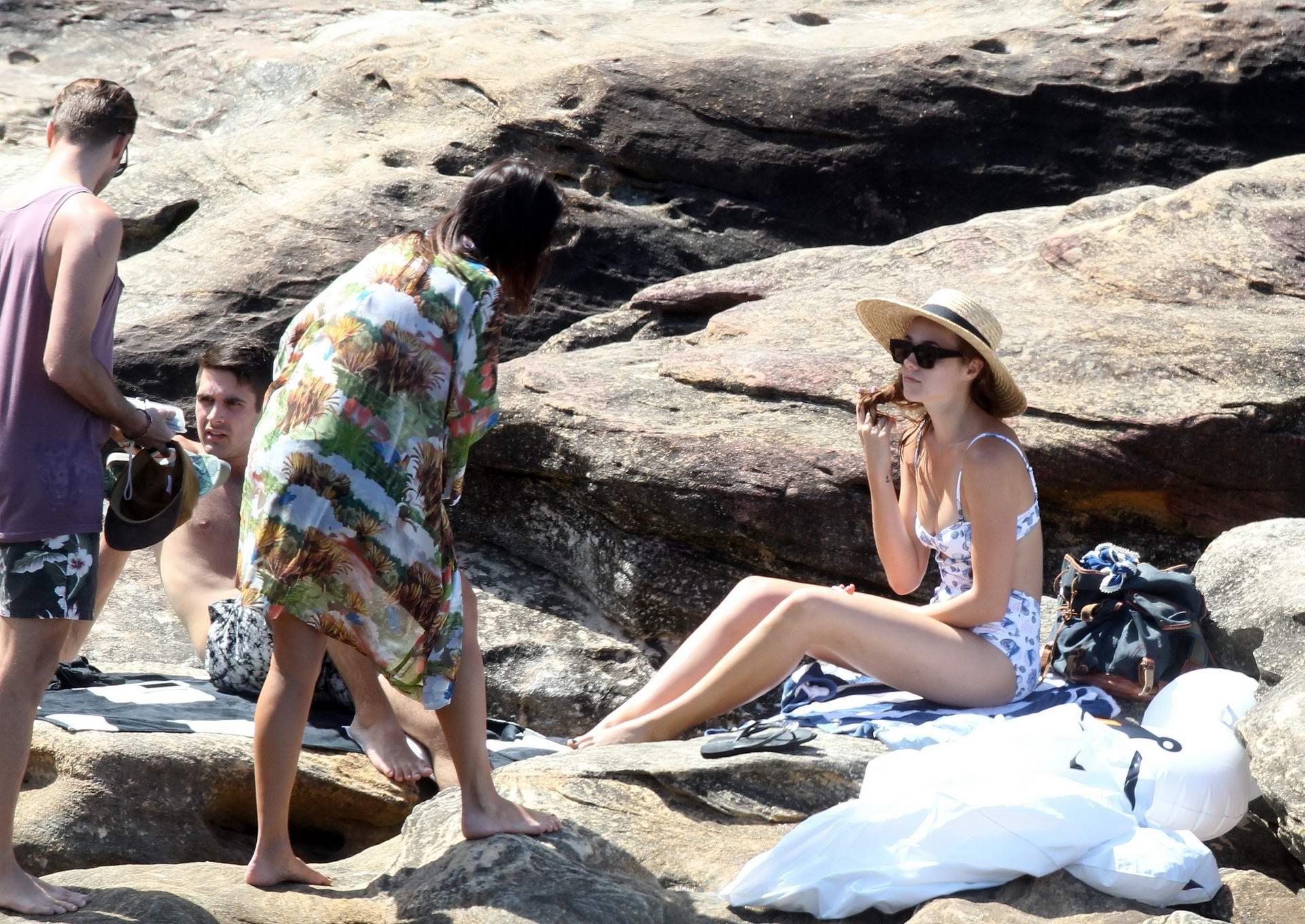 16P Demi Harman busty wearing a swimsuit on a rocky beach in Sydney