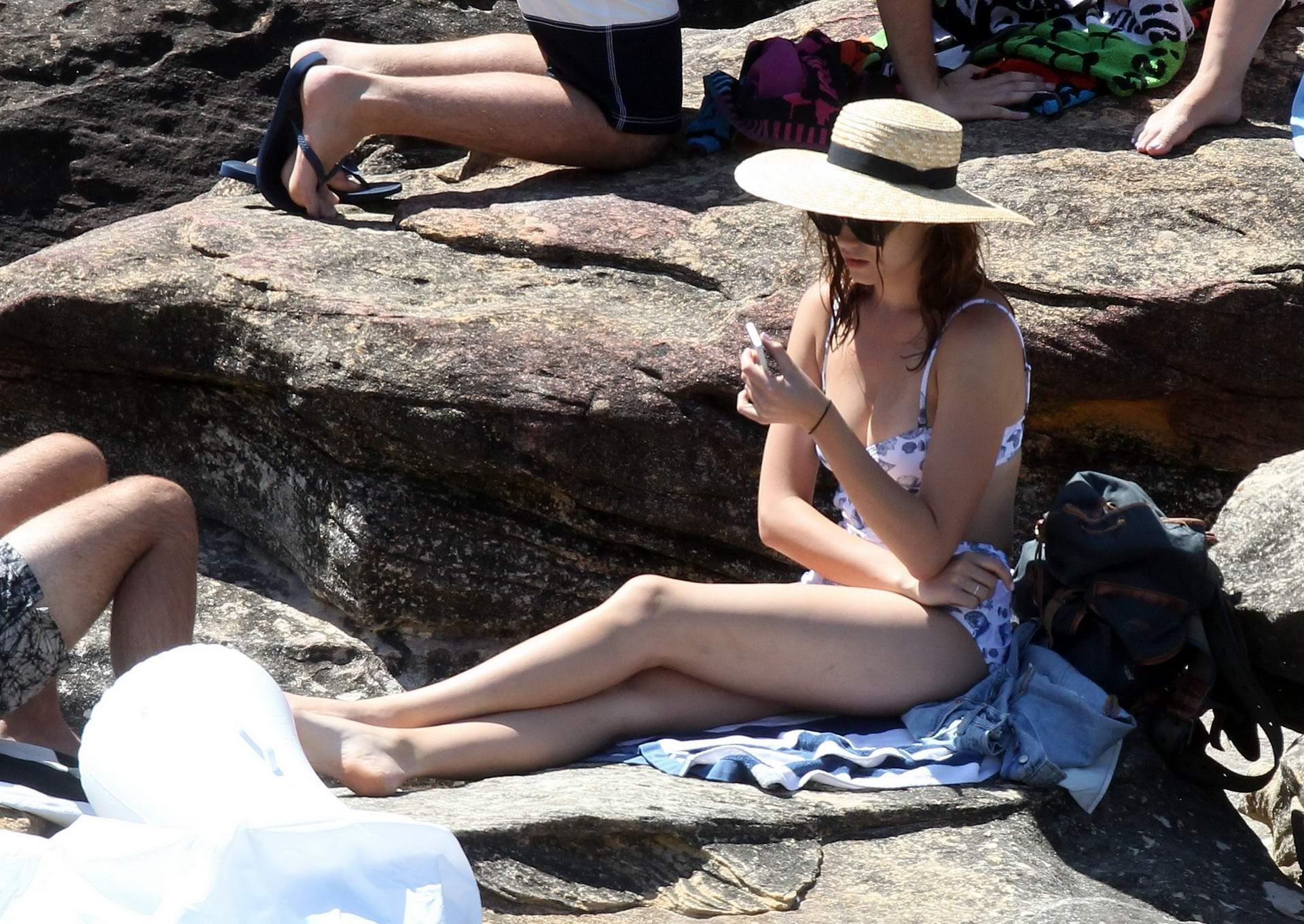 16P Demi Harman busty wearing a swimsuit on a rocky beach in Sydney