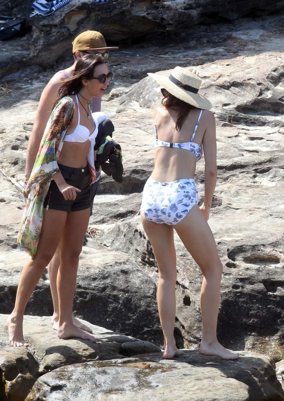16P Demi Harman busty wearing a swimsuit on a rocky beach in Sydney