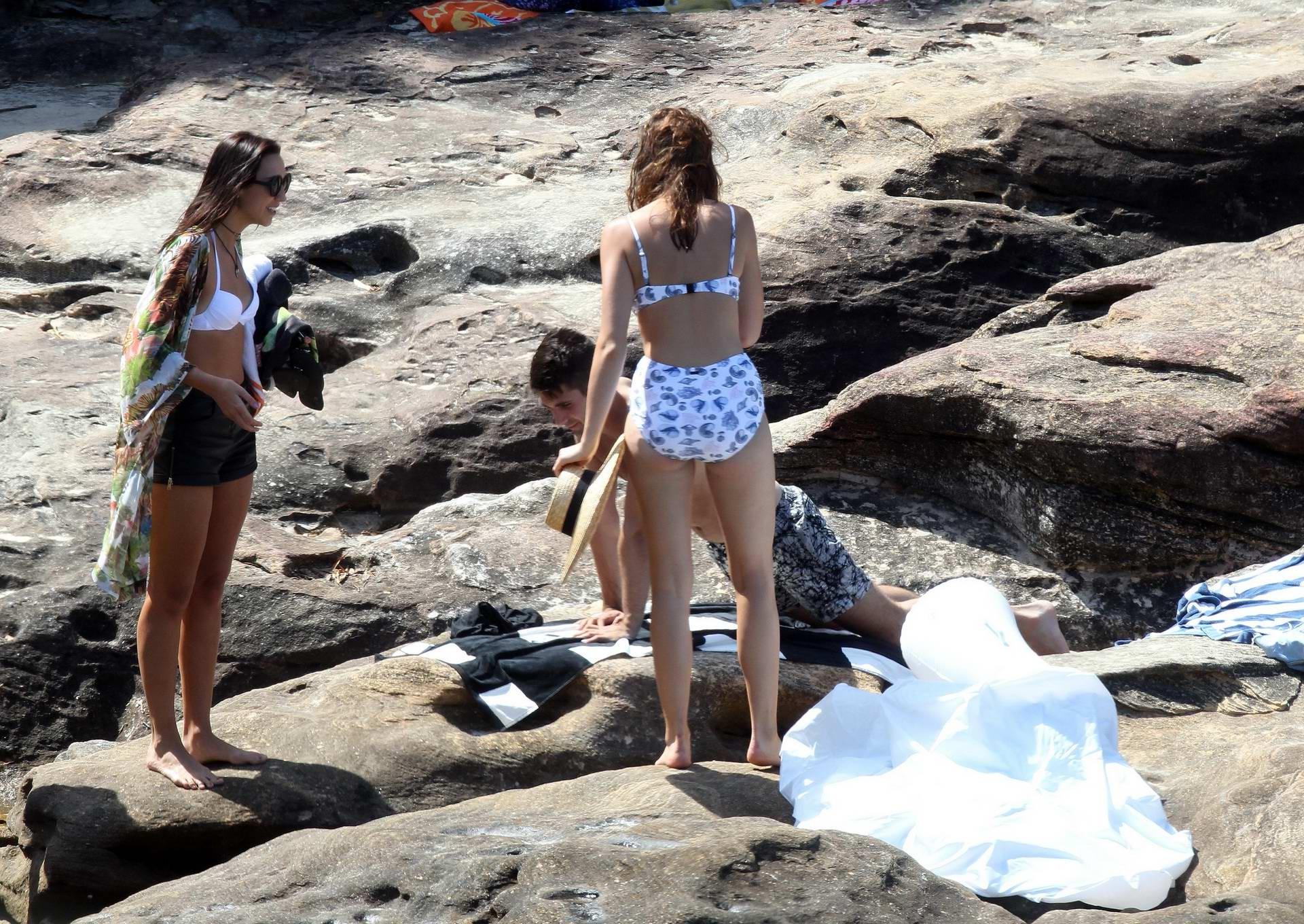 16P Demi Harman busty wearing a swimsuit on a rocky beach in Sydney