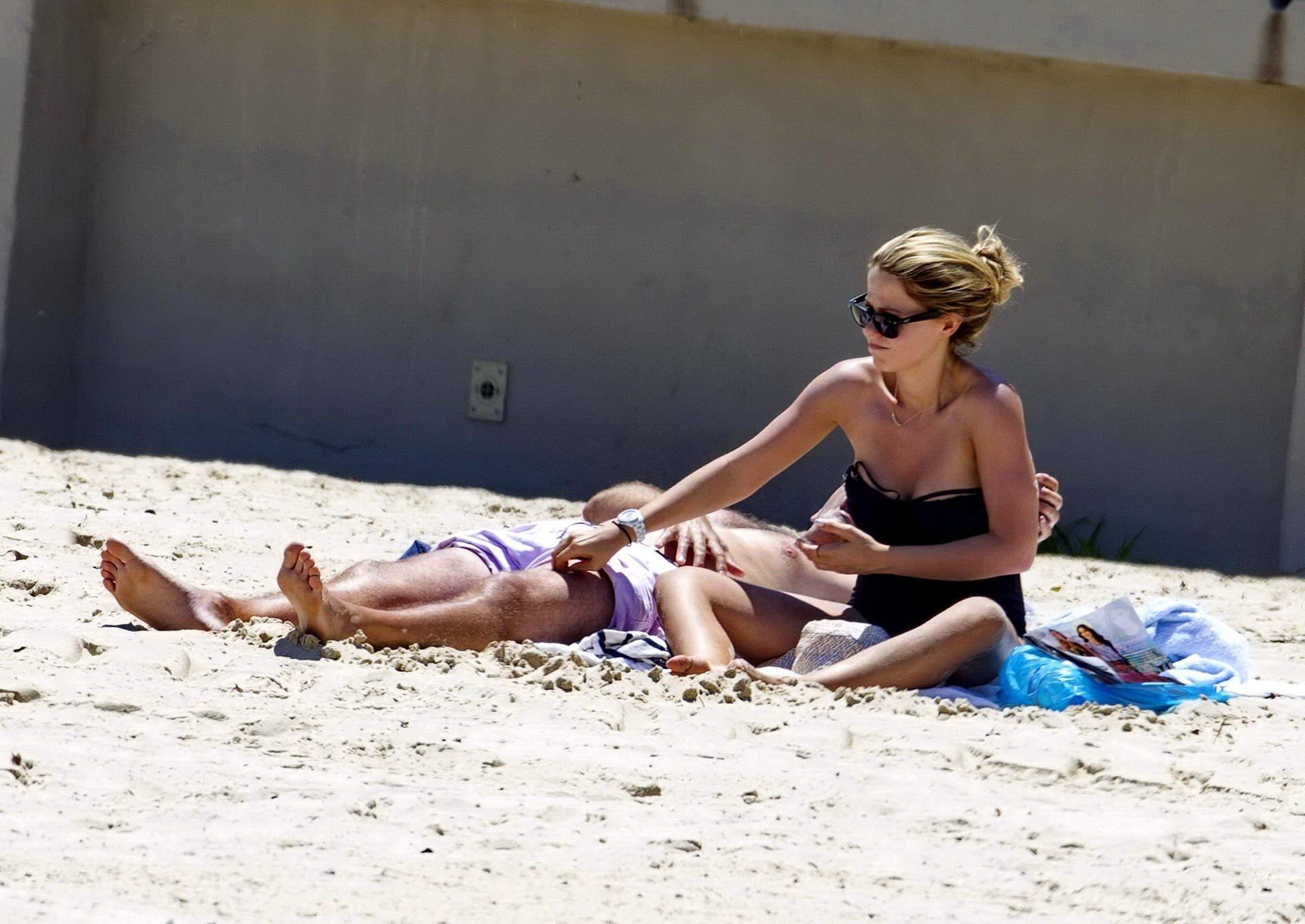 16P Tammin Sursok wearing a black swimsuit on a beach in Sydney