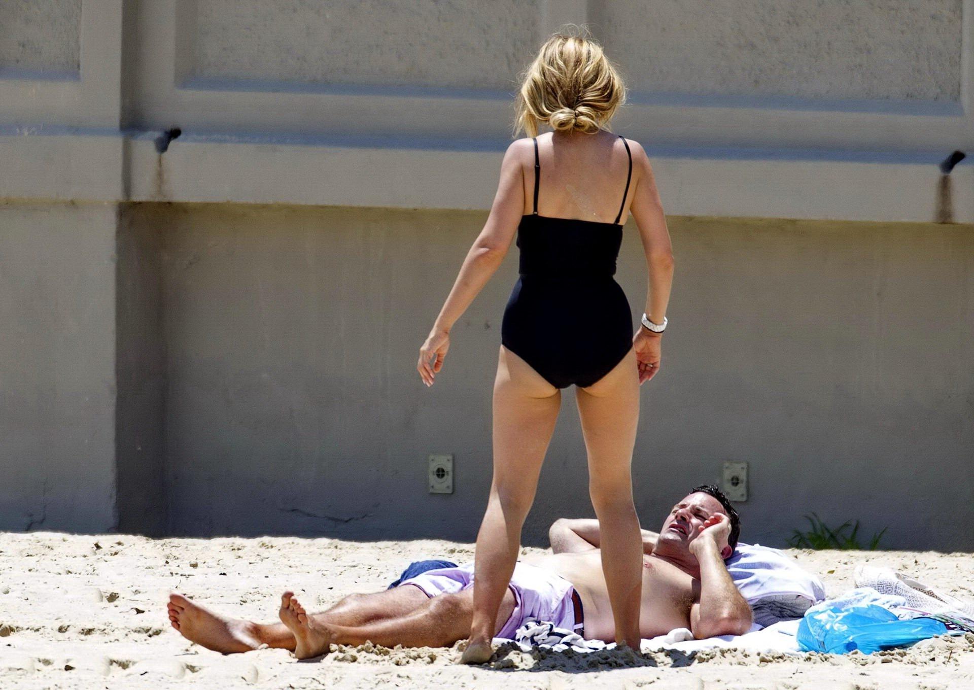 16P Tammin Sursok wearing a black swimsuit on a beach in Sydney