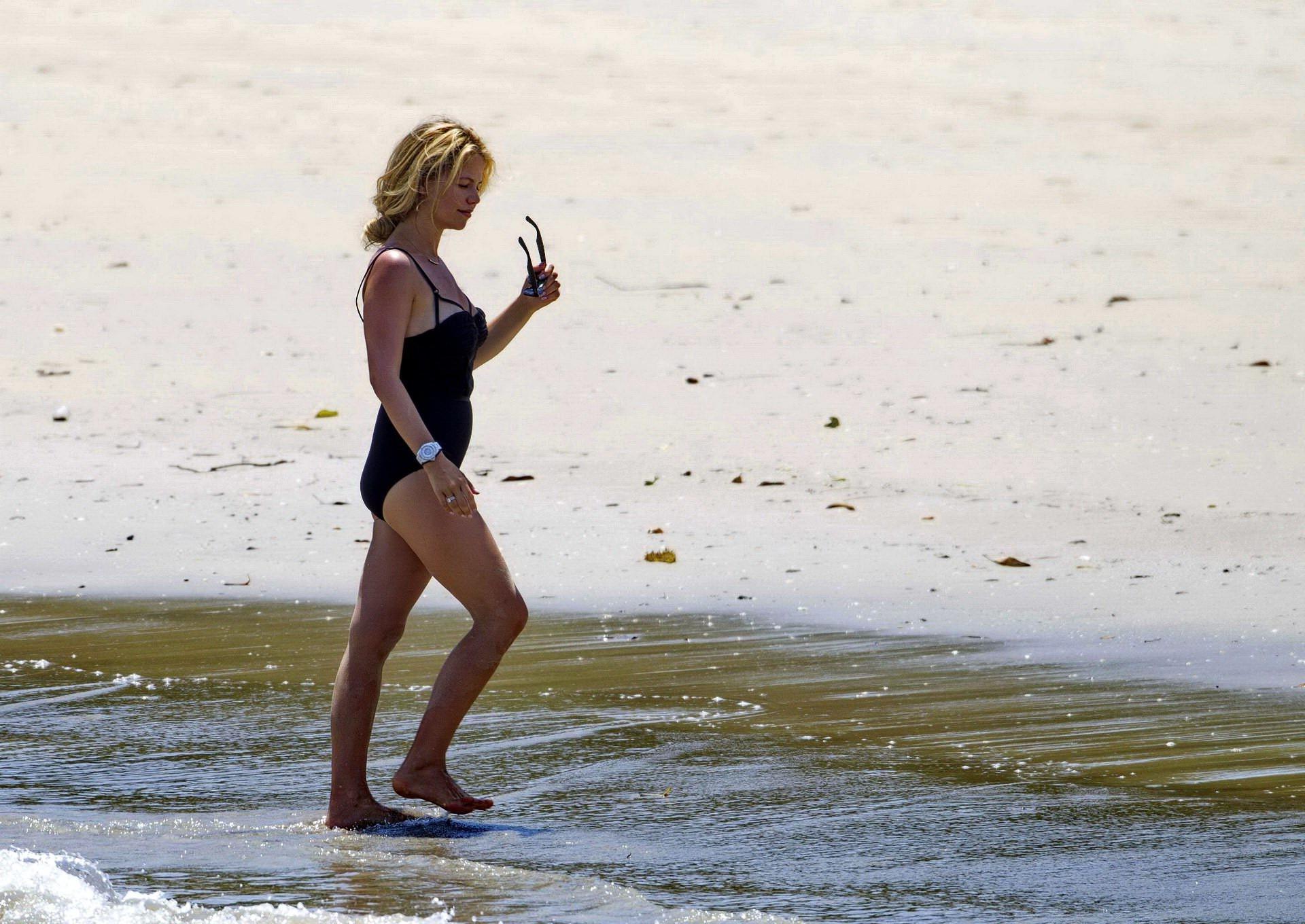16P Tammin Sursok wearing a black swimsuit on a beach in Sydney