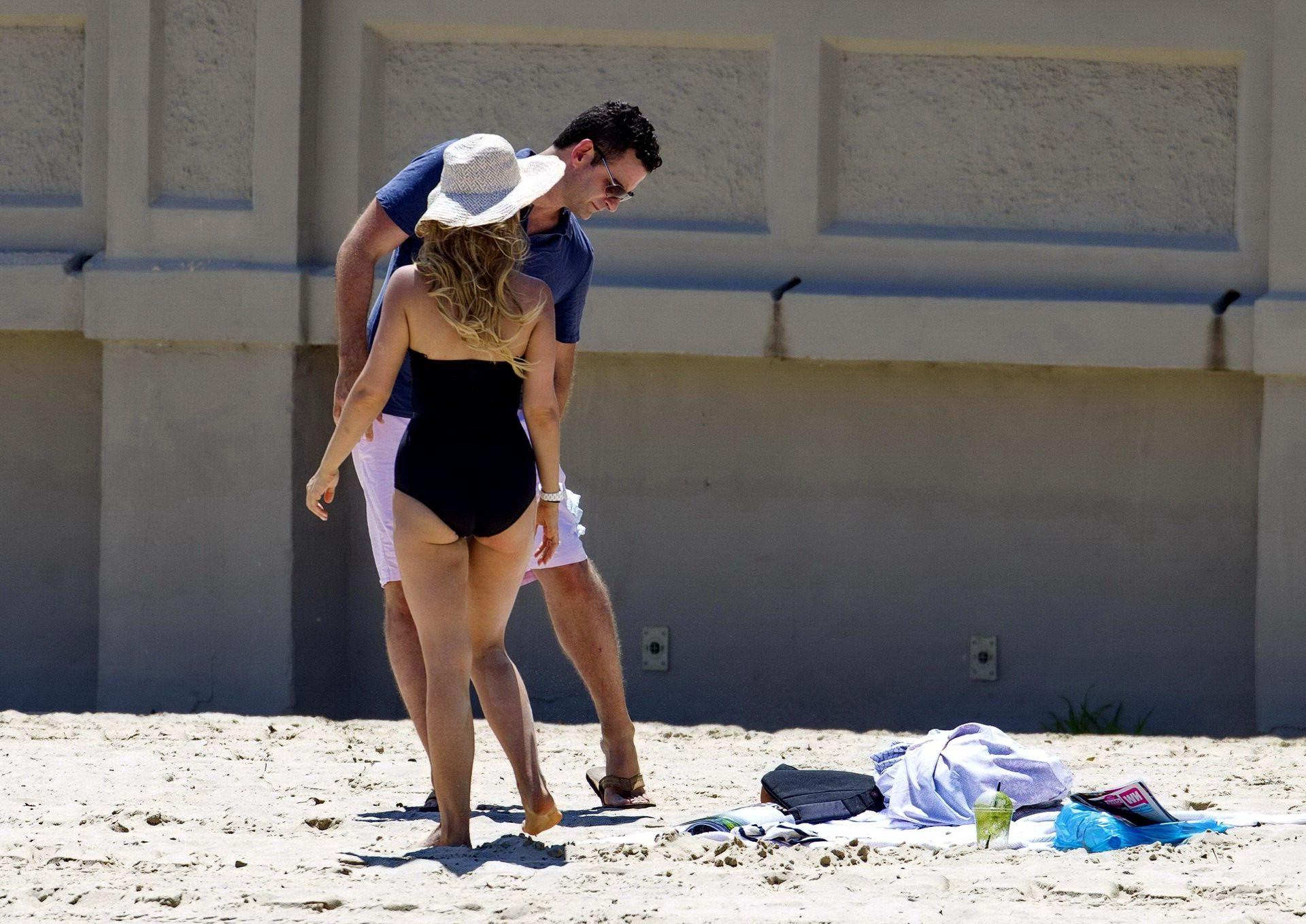16P Tammin Sursok wearing a black swimsuit on a beach in Sydney