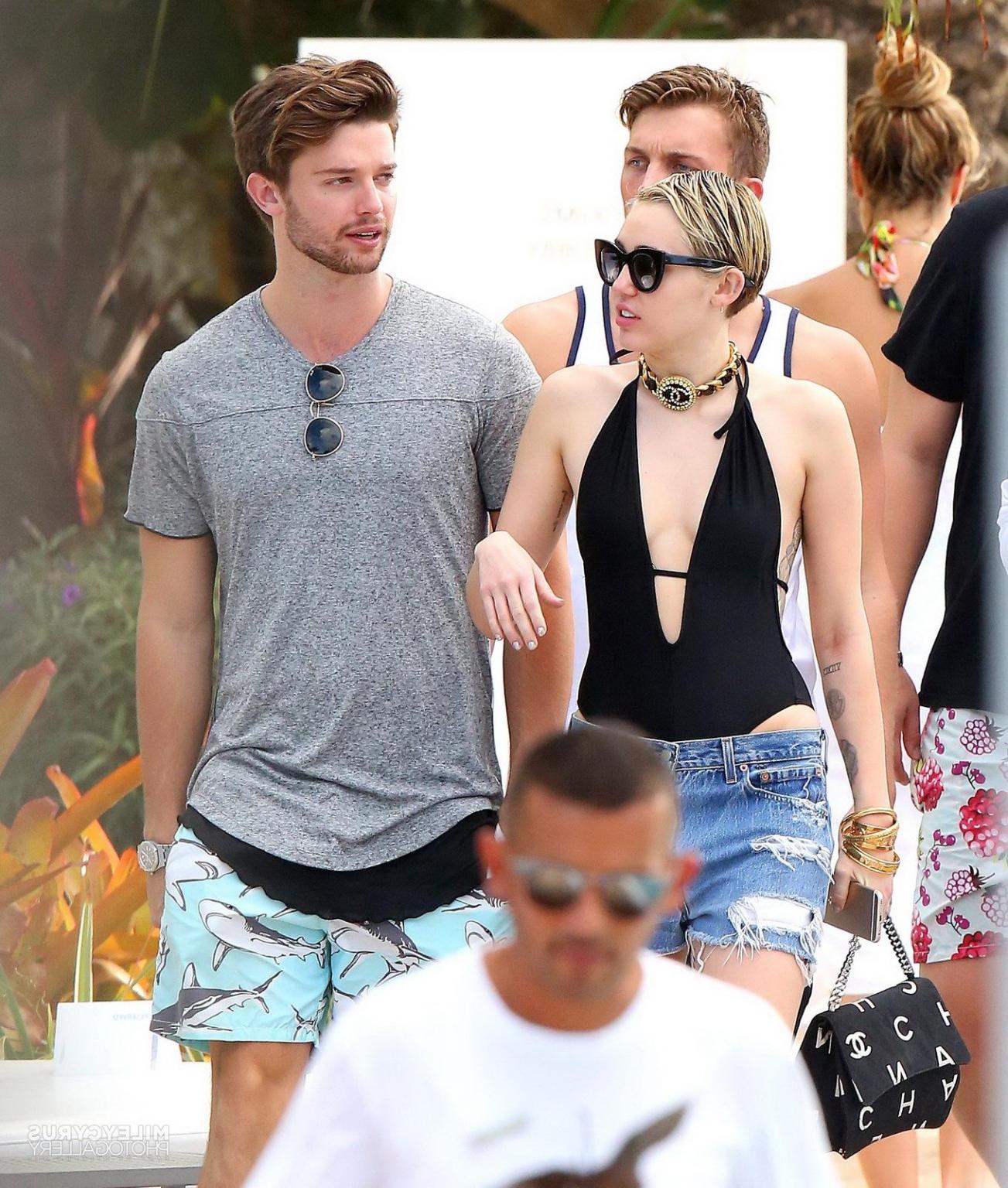 16P Miley Cyrus wearing swimsuit and hotpants at a pool in Miami