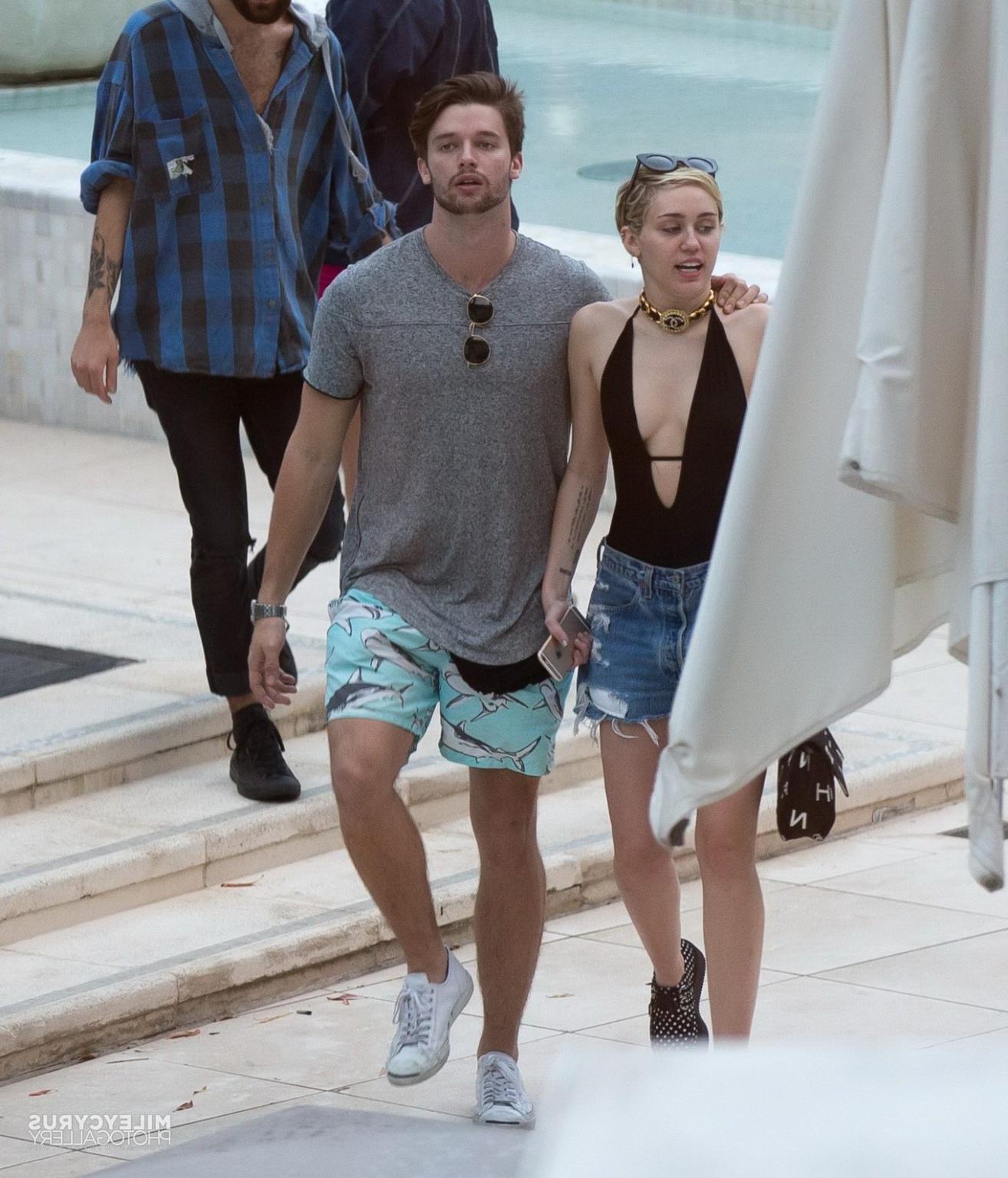 16P Miley Cyrus wearing swimsuit and hotpants at a pool in Miami
