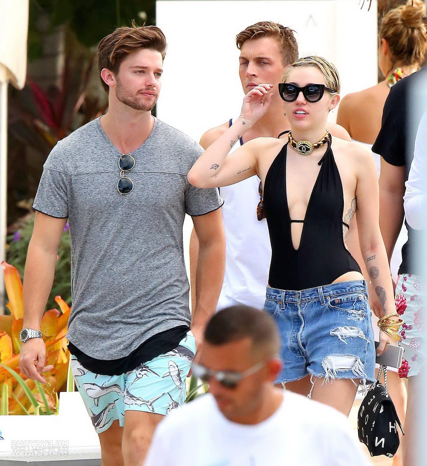 16P Miley Cyrus wearing swimsuit and hotpants at a pool in Miami