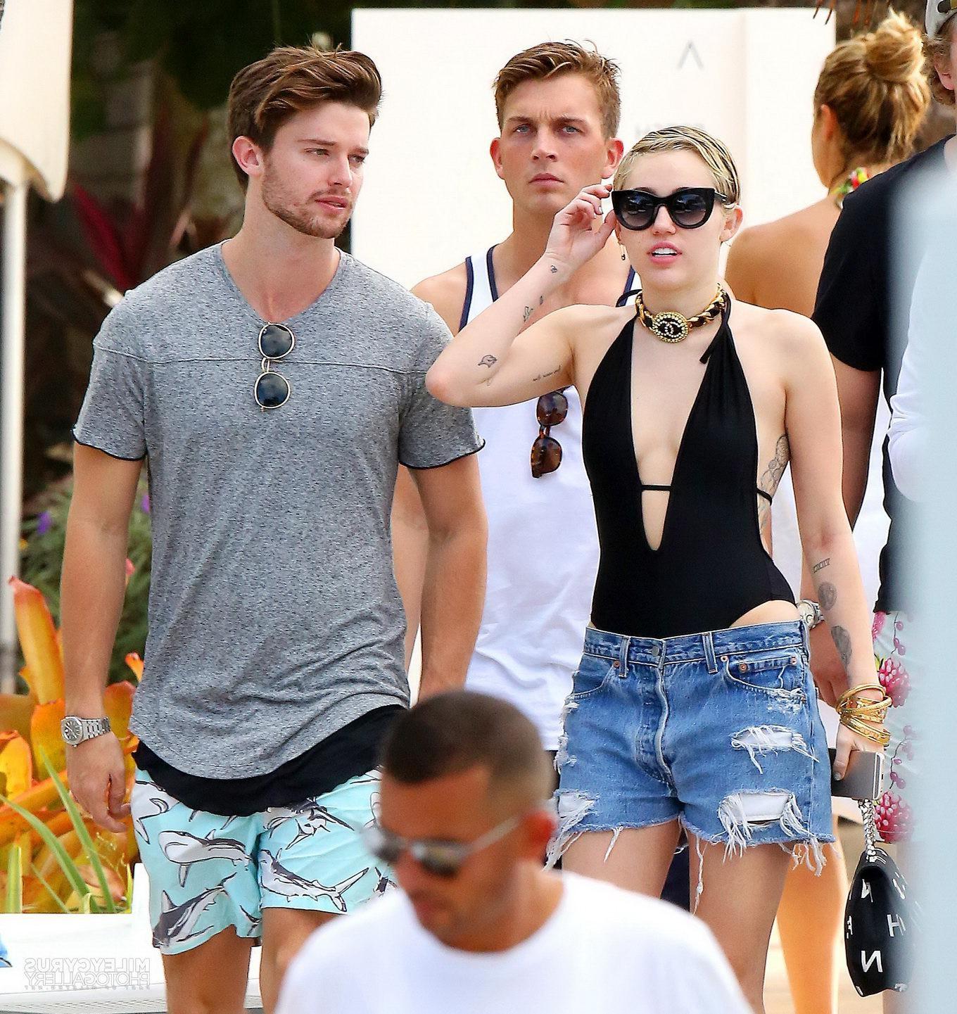 16P Miley Cyrus wearing swimsuit and hotpants at a pool in Miami