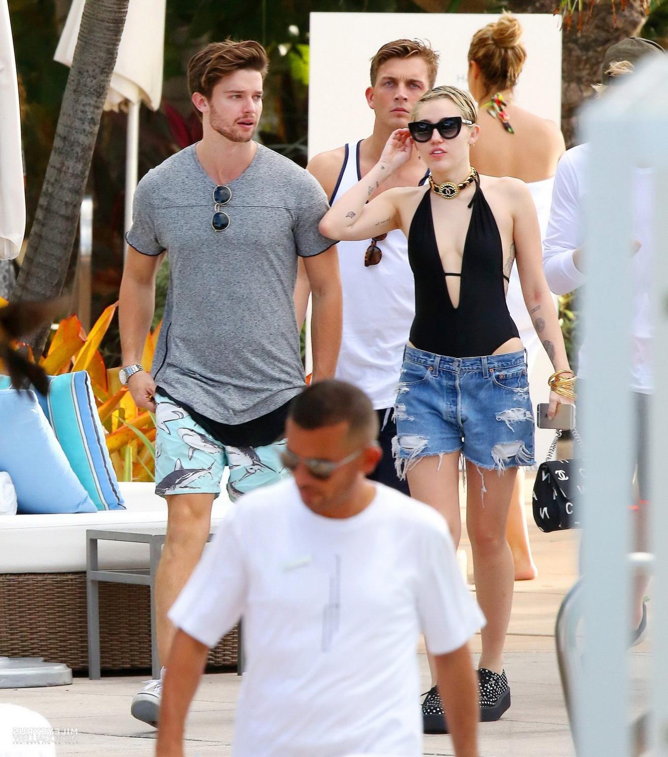 16P Miley Cyrus wearing swimsuit and hotpants at a pool in Miami